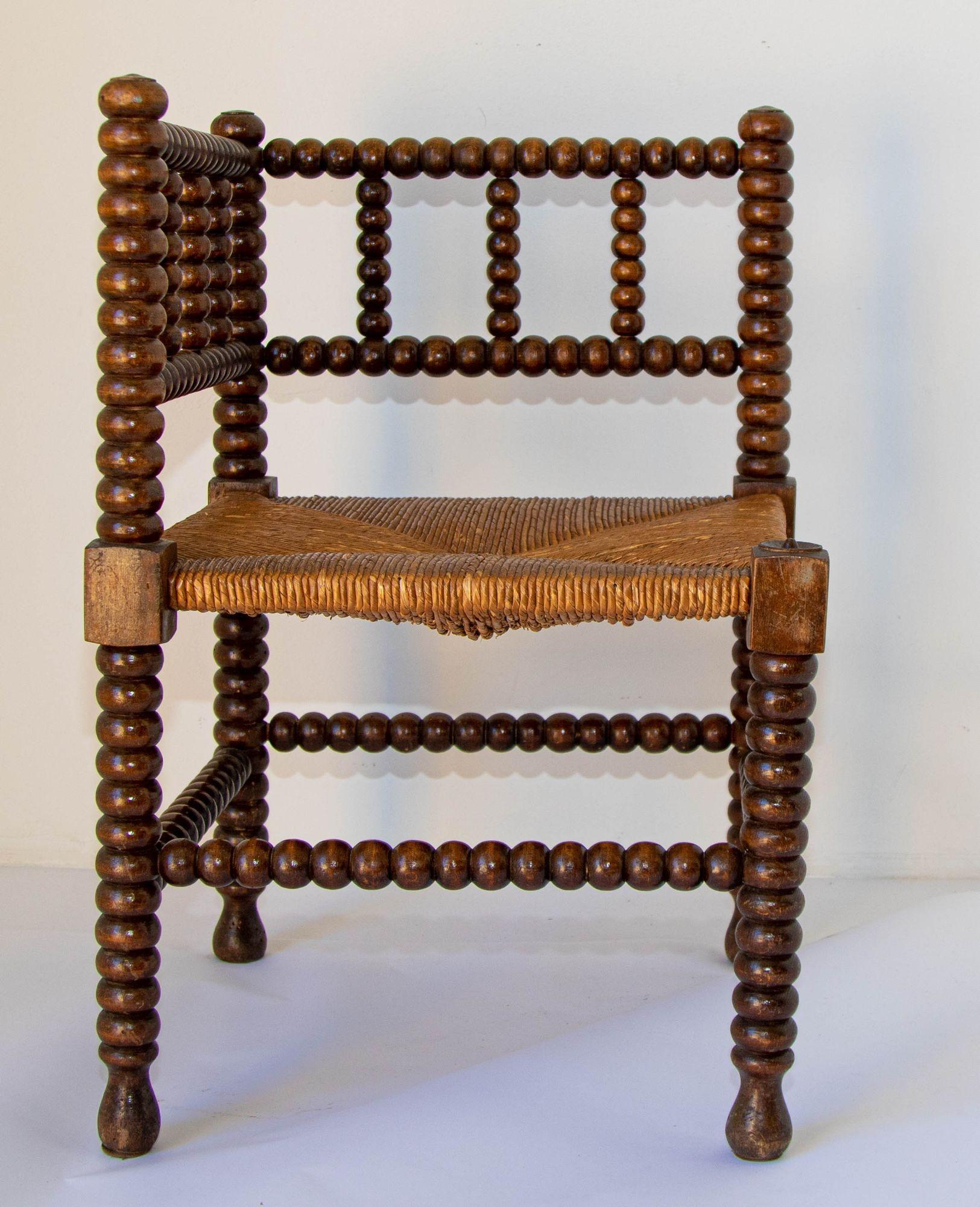 Antique 19th c. French Bobbin rush corner chair.
French rush-seat corner chair, Coin du Feu.
19th Century French Provincial-style carved oak armchair with open backs and rush seat.
Antique sturdy useable chair, wood stick and ball craftsmanship