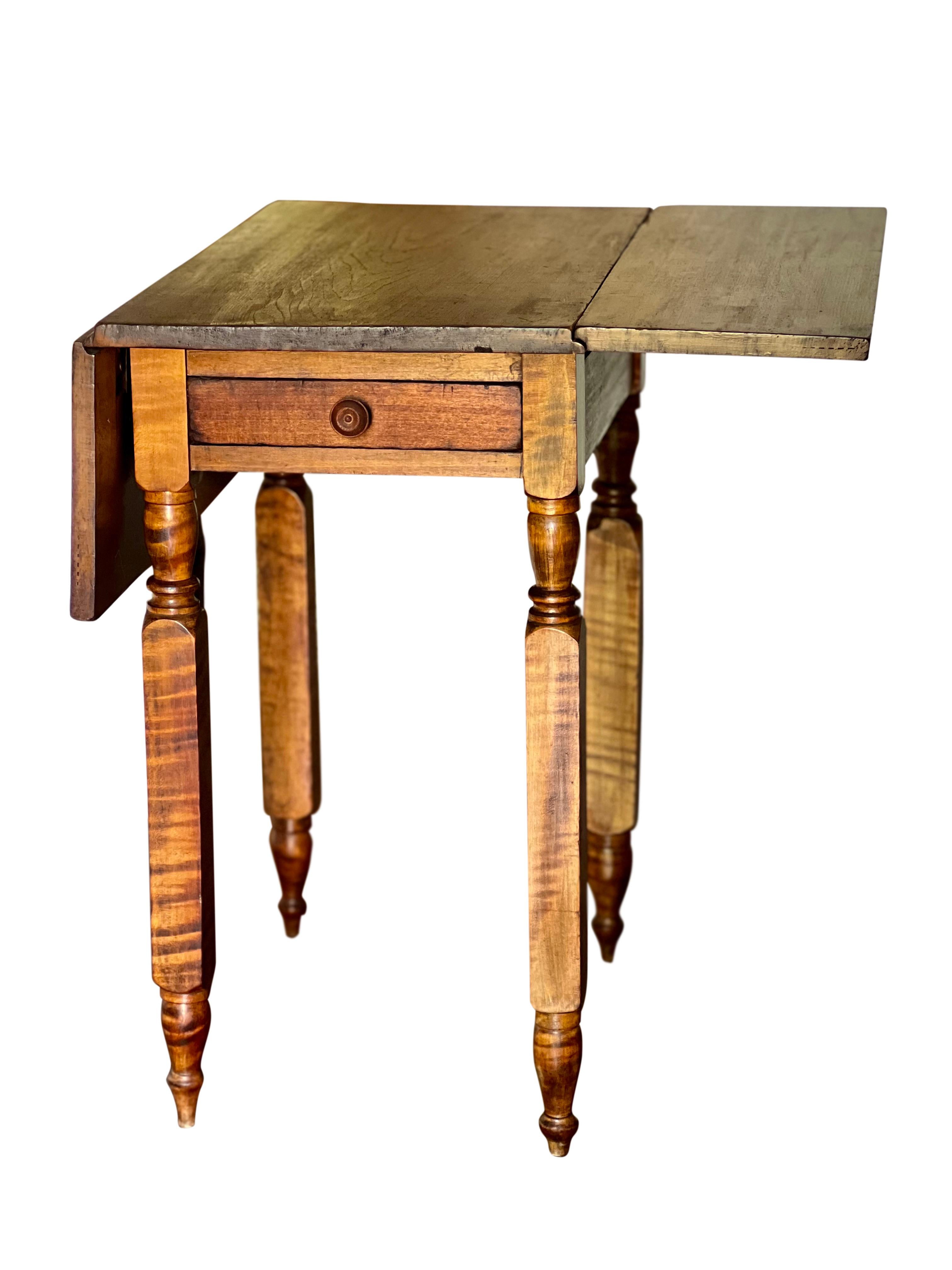 French Provincial walnut drop-leaf harvest table, France, c. 1890.

A charming table handcrafted in a French farmhouse barn workshop. It features a single dovetail drawer with matching walnut knob and hand turned legs. Two leaves fully extend the