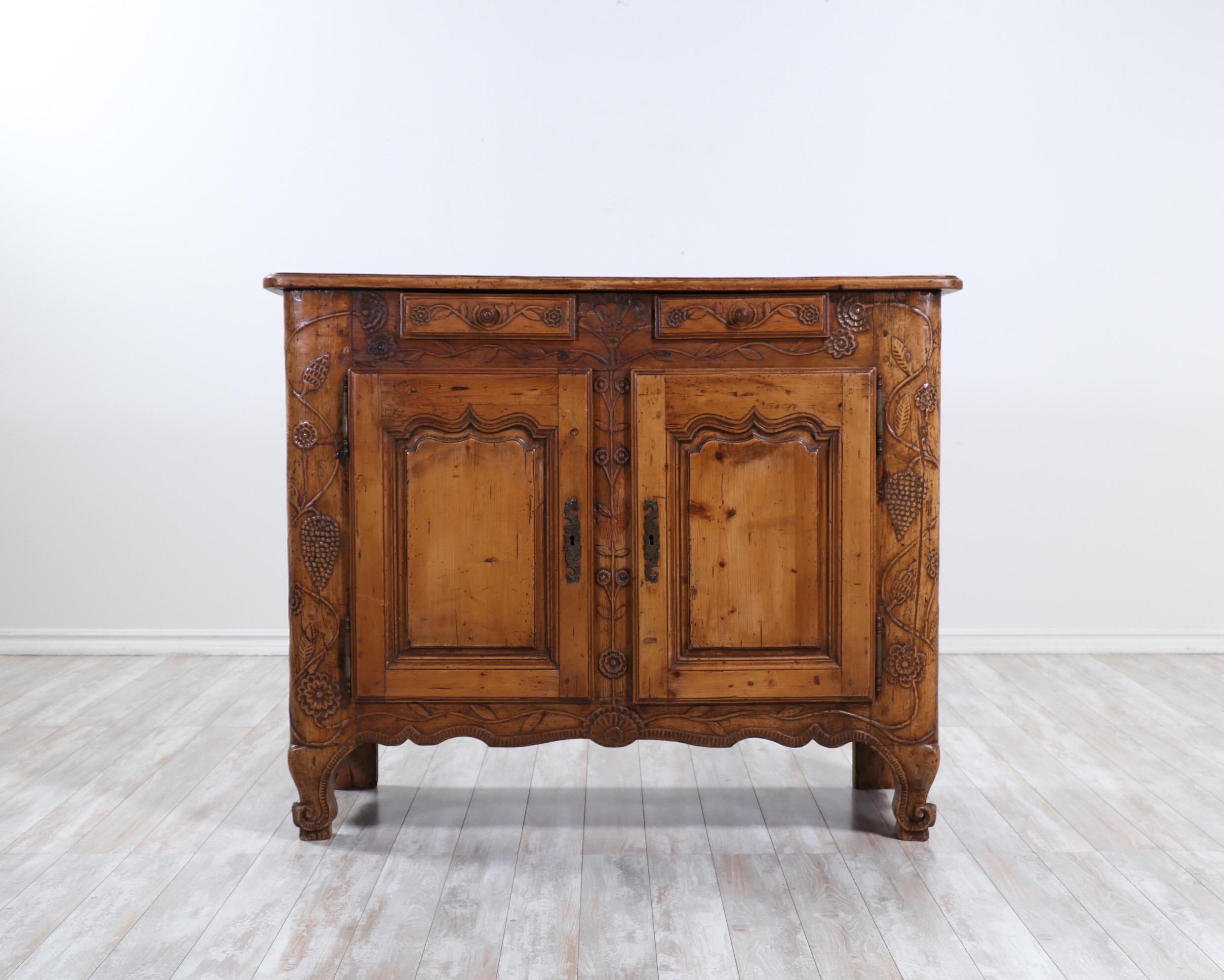 Gorgeous, French late 19th century sideboard with carved floral decorations in the provincial style.

The sideboard offers plenty of storage space, is solidly constructed, sturdy and ready for many more years of use and enjoyment. 

 