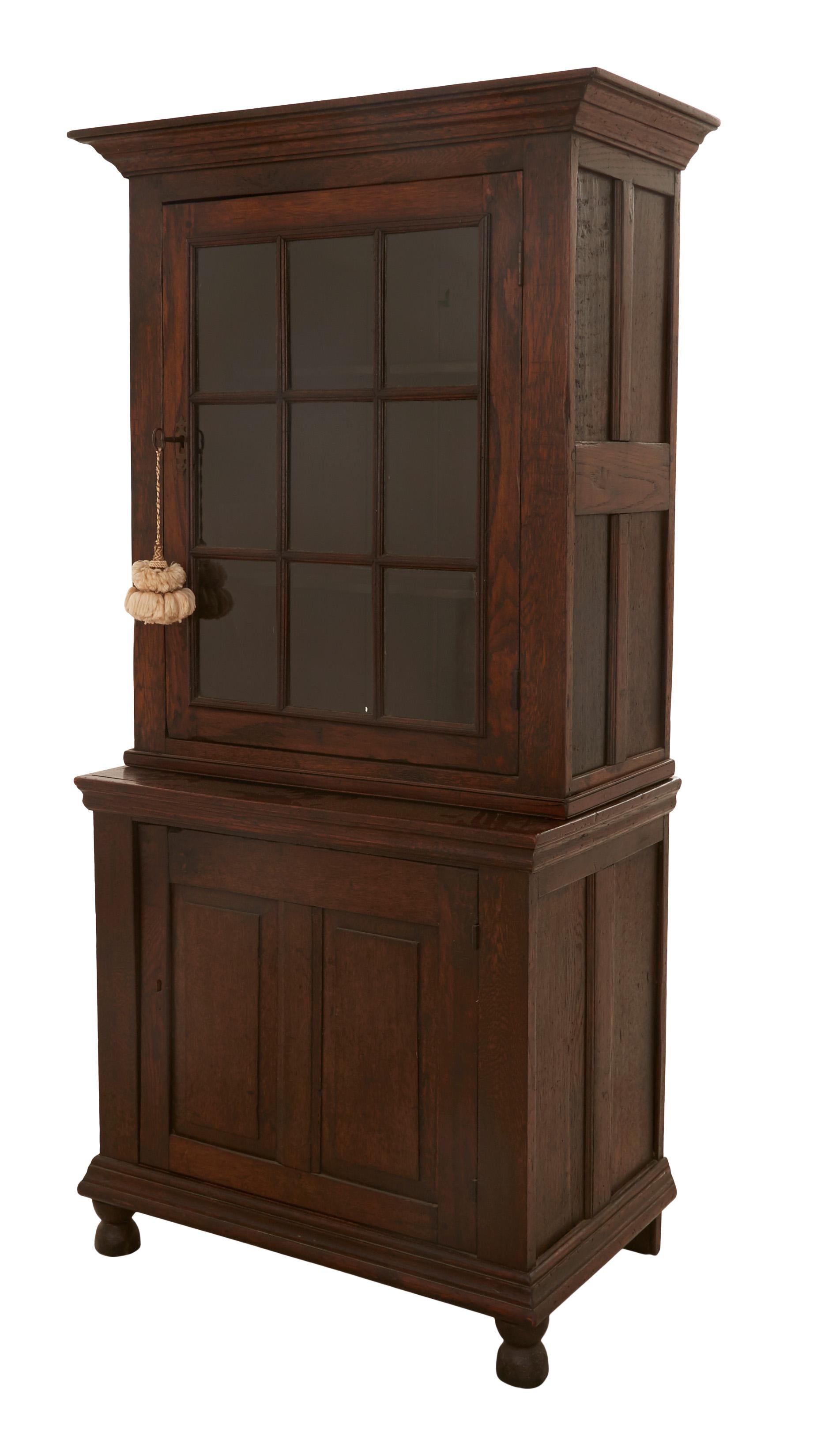 • Walnut
• 2 pieces (top and bottom)
• Top glass paneled door
• Early 20th century
• American

Dimensions
• Overall: 35