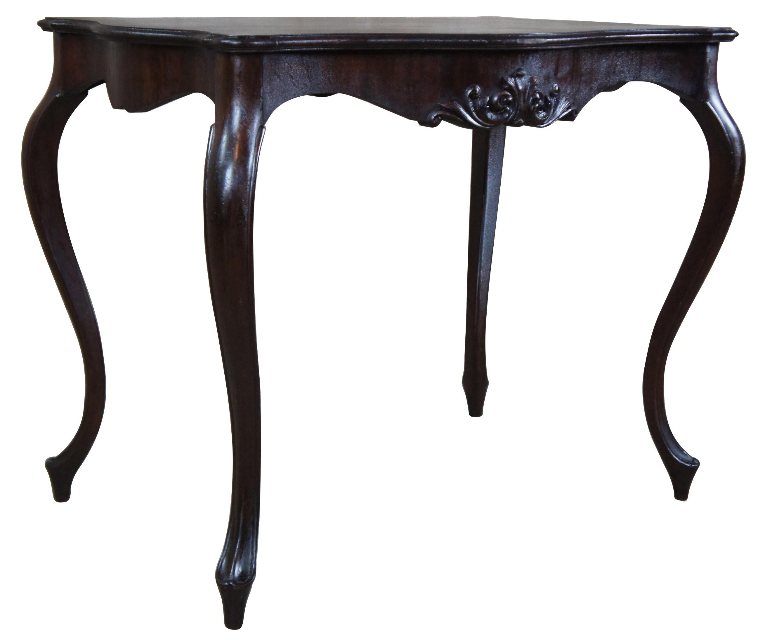 French Provincial side table or desk, circa 1940s. Features a serpentine top over a scalloped apron and long swooping cabriole legs.
  