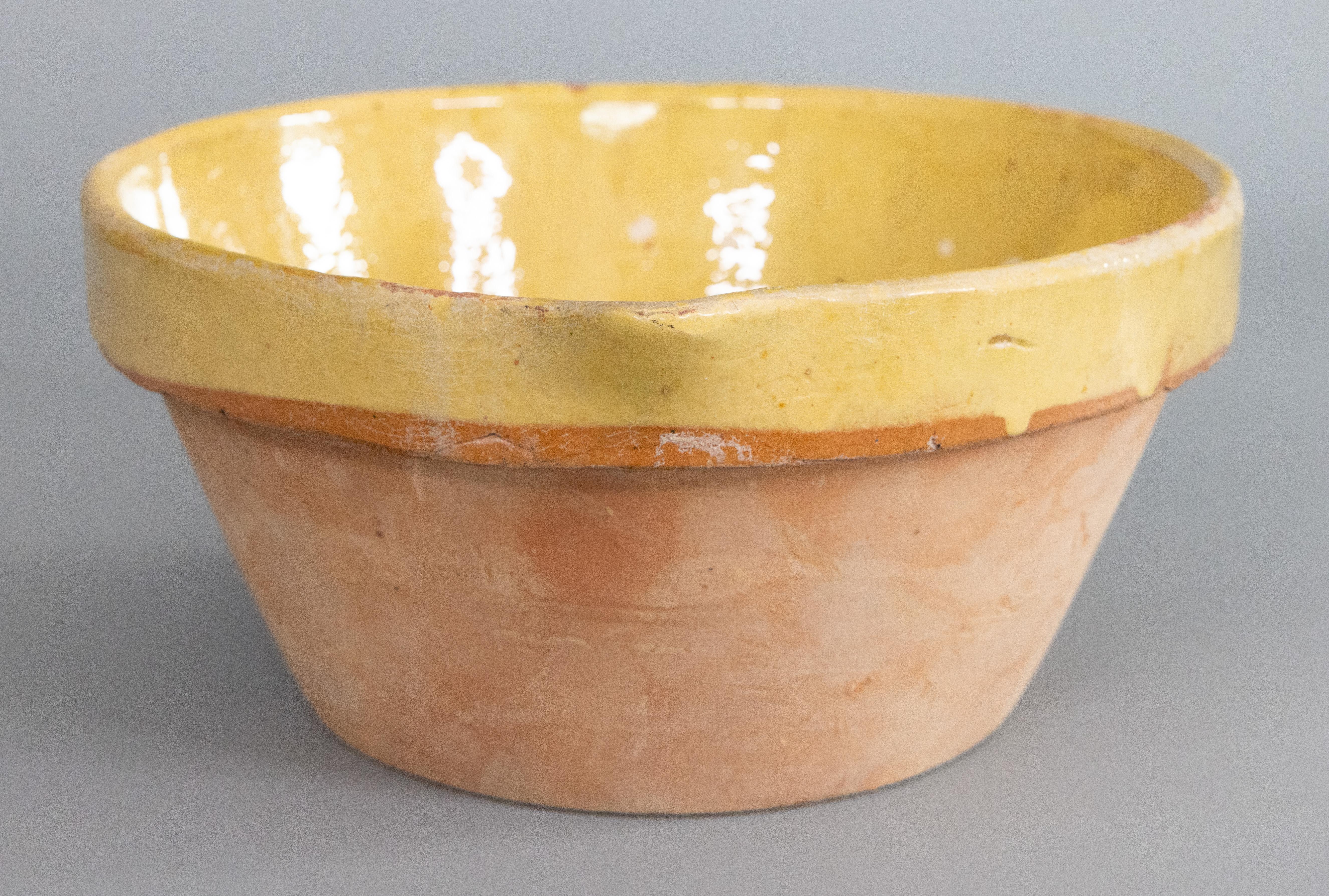 A lovely antique French Provincial yellow glazed terracotta tian or dairy bowl, circa 1900. These charming earthenware dishes originated in Provence and were used for mixing, cooking, and serving, going straight from the oven to the table. It would