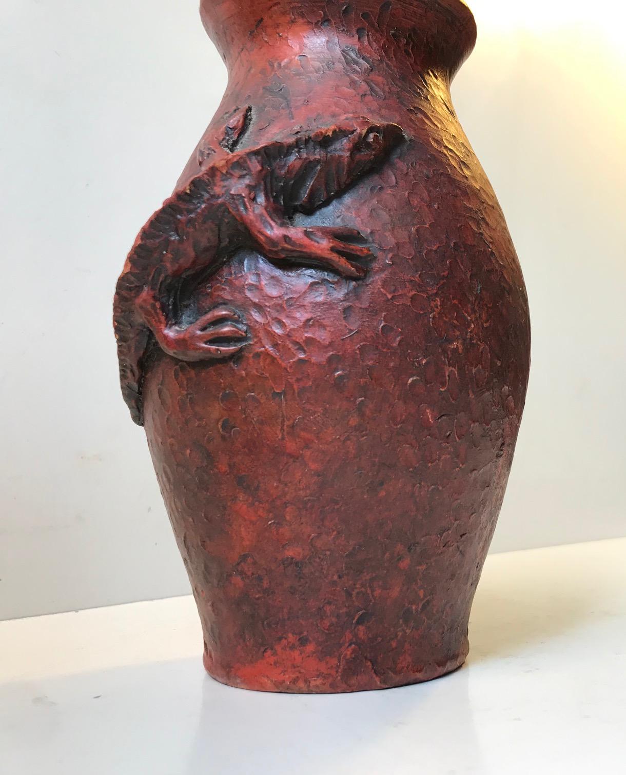 Unique red handprinted stoneware vase with lizard in relief. Its has a modern expression about it that flirts with the stylistics of Art Nouveau and Art Deco. The style of this particular vase is reminiscent of works by the French master Edmond