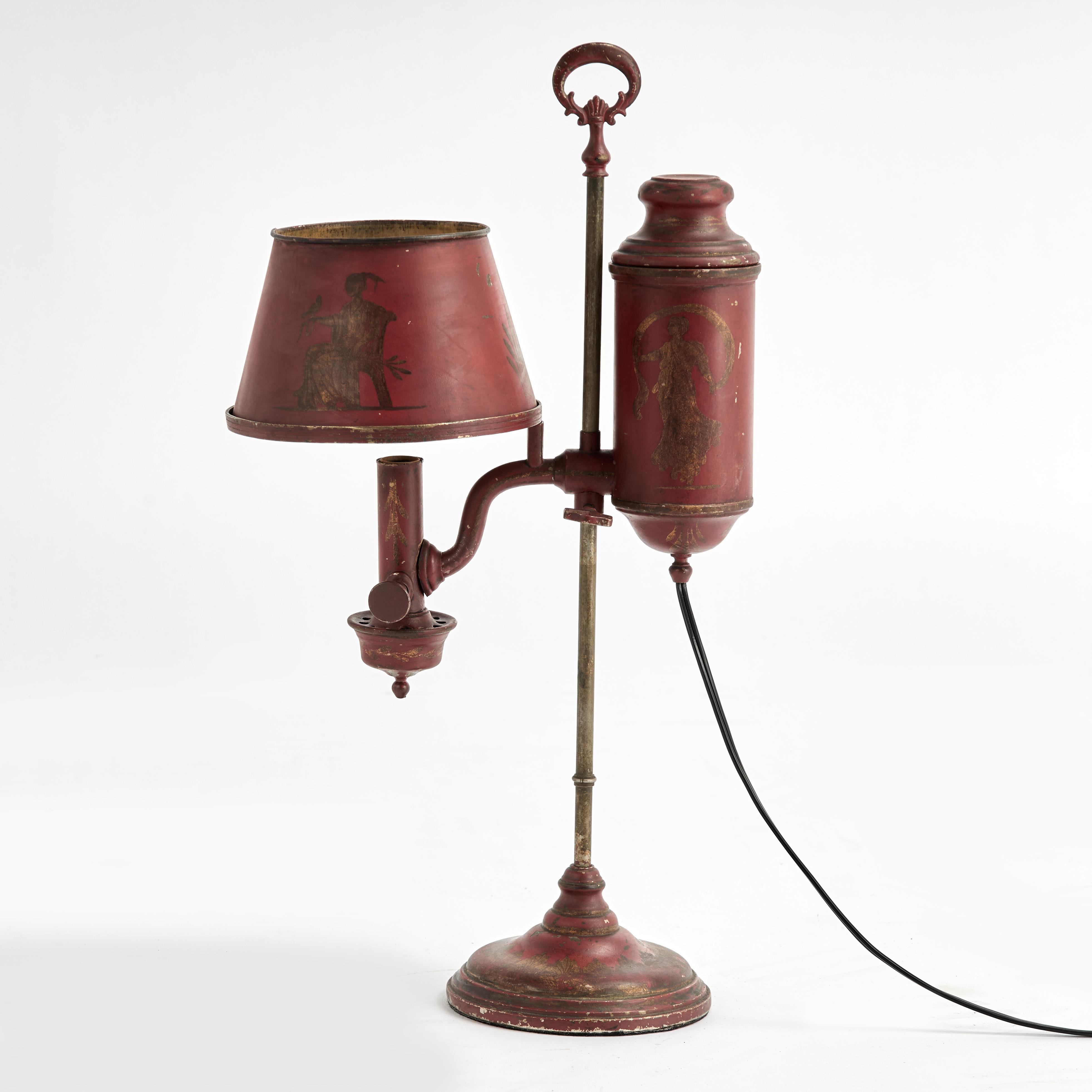 Standout 19th century French tole bouillotte table lamp, now electric once oil, with adjustable height, featuring the original alluring red paint hand decorated with gilt classical designs worn to perfection. 