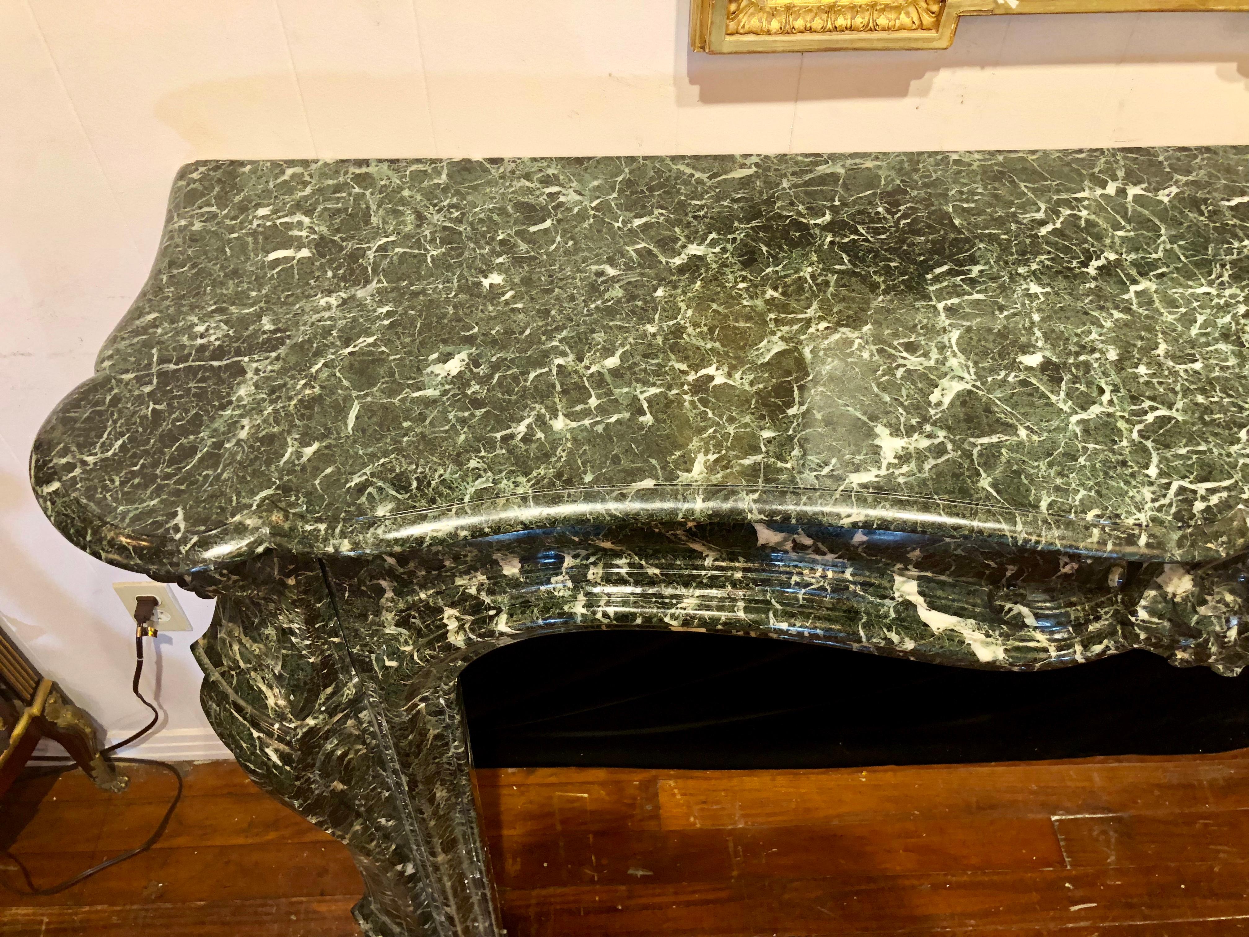 Large Antique French Régence green marble mantel, circa 1860. An amazing piece. We would be happy to send more photos of the marble to show its lovely color.