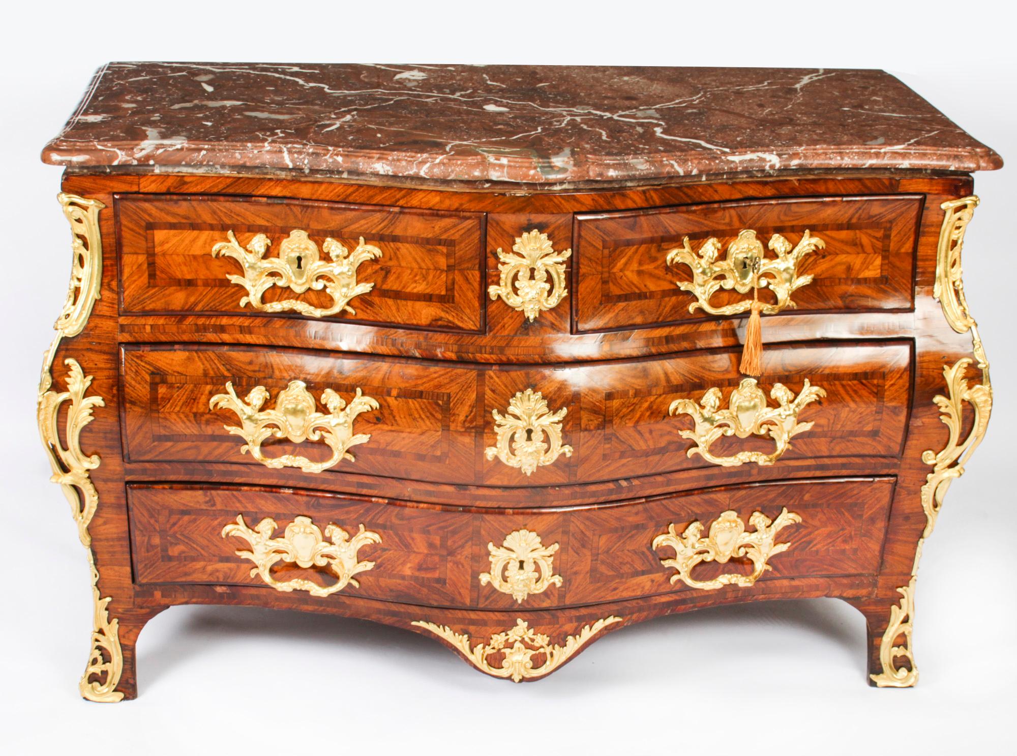 This is an impressive and rare antique French Régence wood and ormolu mounted commode, circa 1720 in date.
 
The stunning breche violette marble top over a serpentine front having two short over two full width drawers, the drawers fitted with