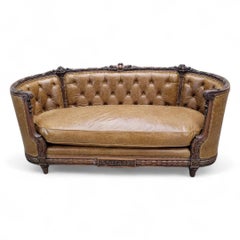 Antique French Regency Mahogany Carved And Curved Sofa Reupholstered In Leather