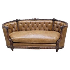 Antique French Regency Mahogany Carved And Curved Sofa Reupholstered In Leather