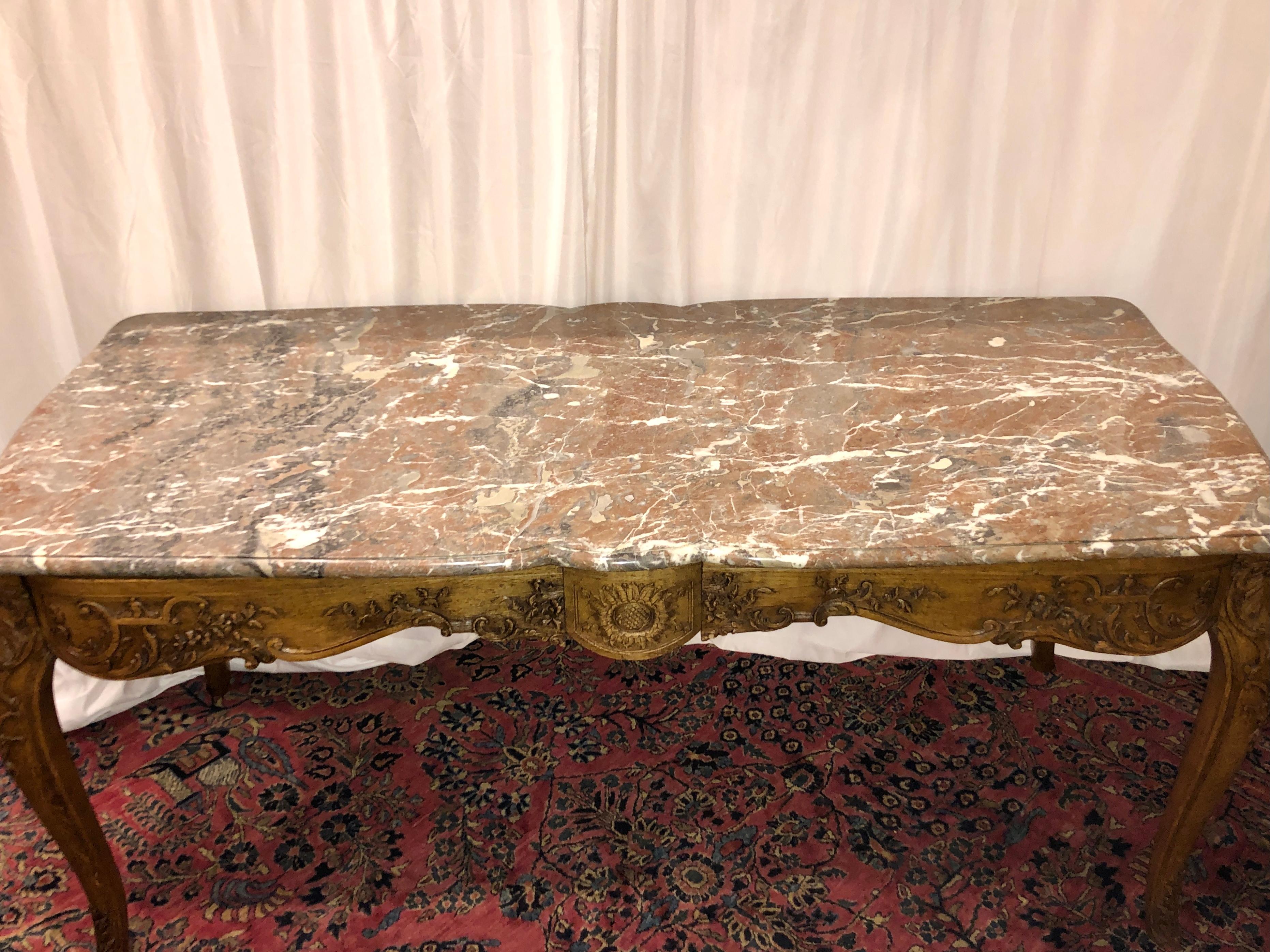 Antique French regency marble top and carved wood center table.