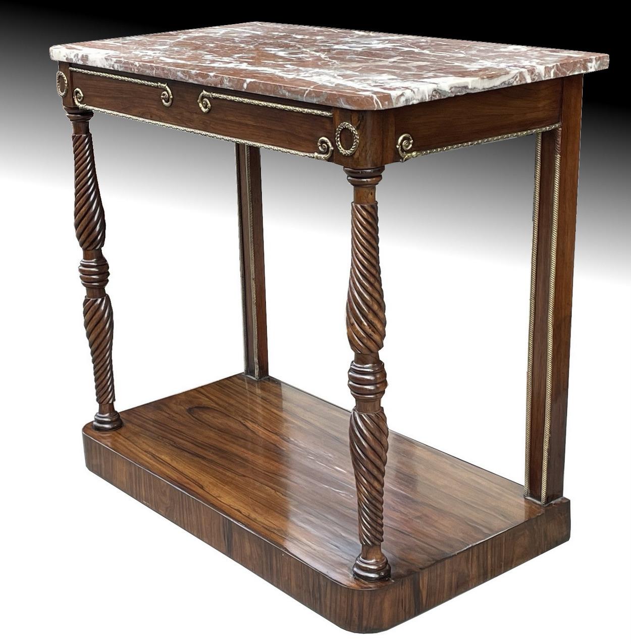 An exceptionally fine and imposing French well figured mirror backed Regency Period Rosewood well veined Marble topped console table. First quarter of the 19th century. 

The rectangular top above an attractive ormolu frieze, raised on turned and