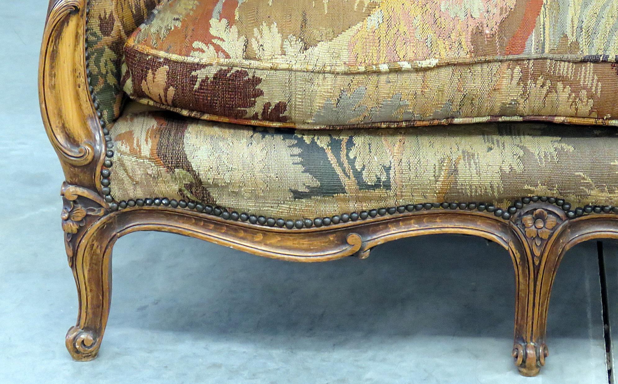 Antique French Regency style needlepoint sofa with nailhead trim.