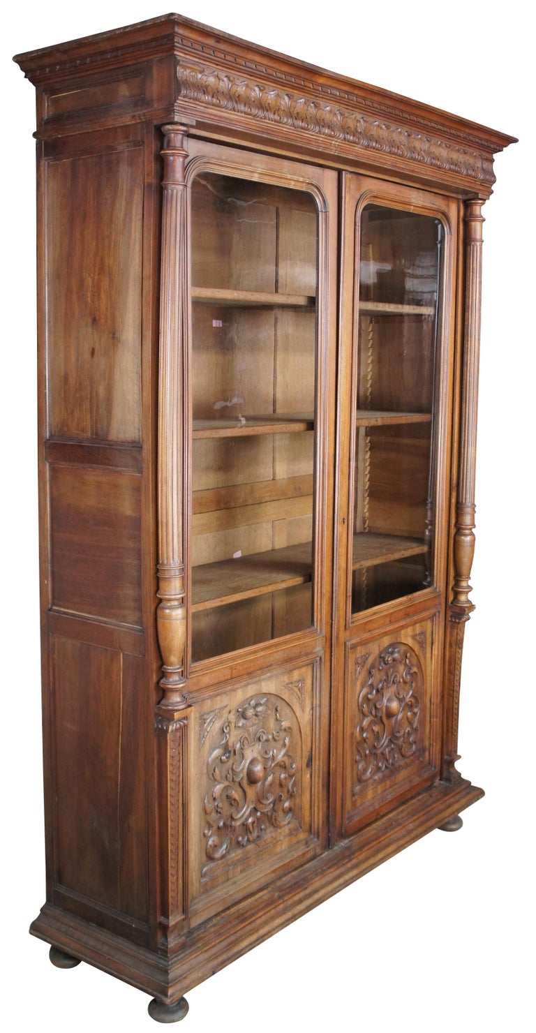 An exquisite French Renaissance Revival Bibliotheque, Linen press or display cabinet. Circa mid 19th cenutry. A large rectangular oak case centered by original 3/4 length glass between turned and fluted columns. Lower side of doors features an inset
