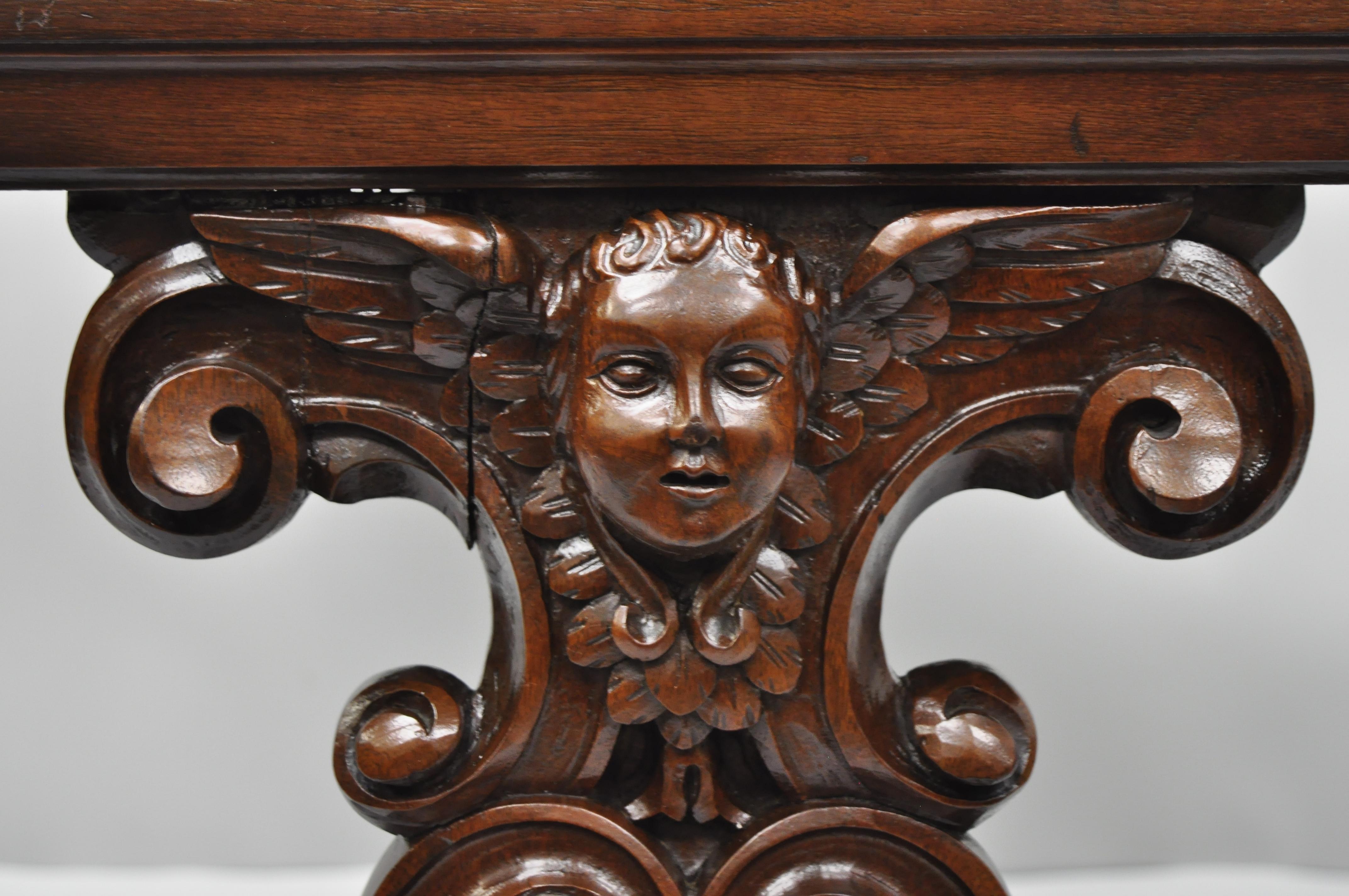 Antique French Renaissance carved cherub angel walnut and marble accent table. Item features ornately carved winged angel faces to sides, inset marble top, and solid wood construction; great style and form, early 20th century. Measurements: 20