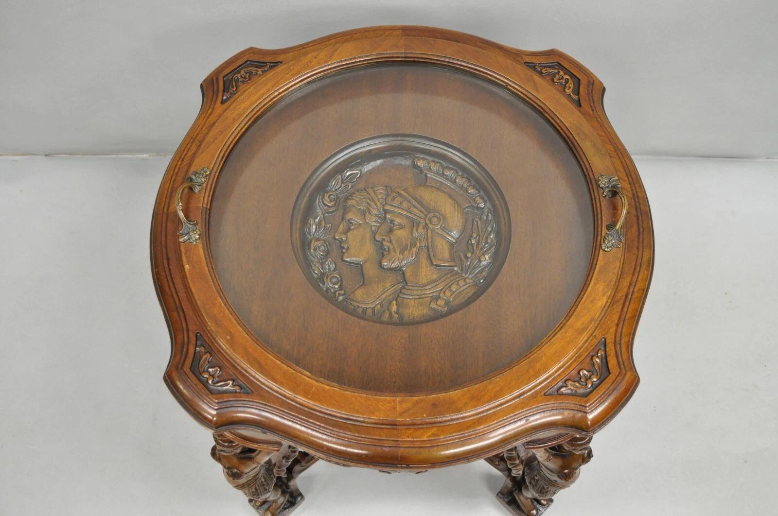 Antique French Renaissance Carved Female Dancer Walnut Coffee Table. Item features a glass display tray top with relief carved soldiers. Circa Early 20th Century. Measurements: 23.5