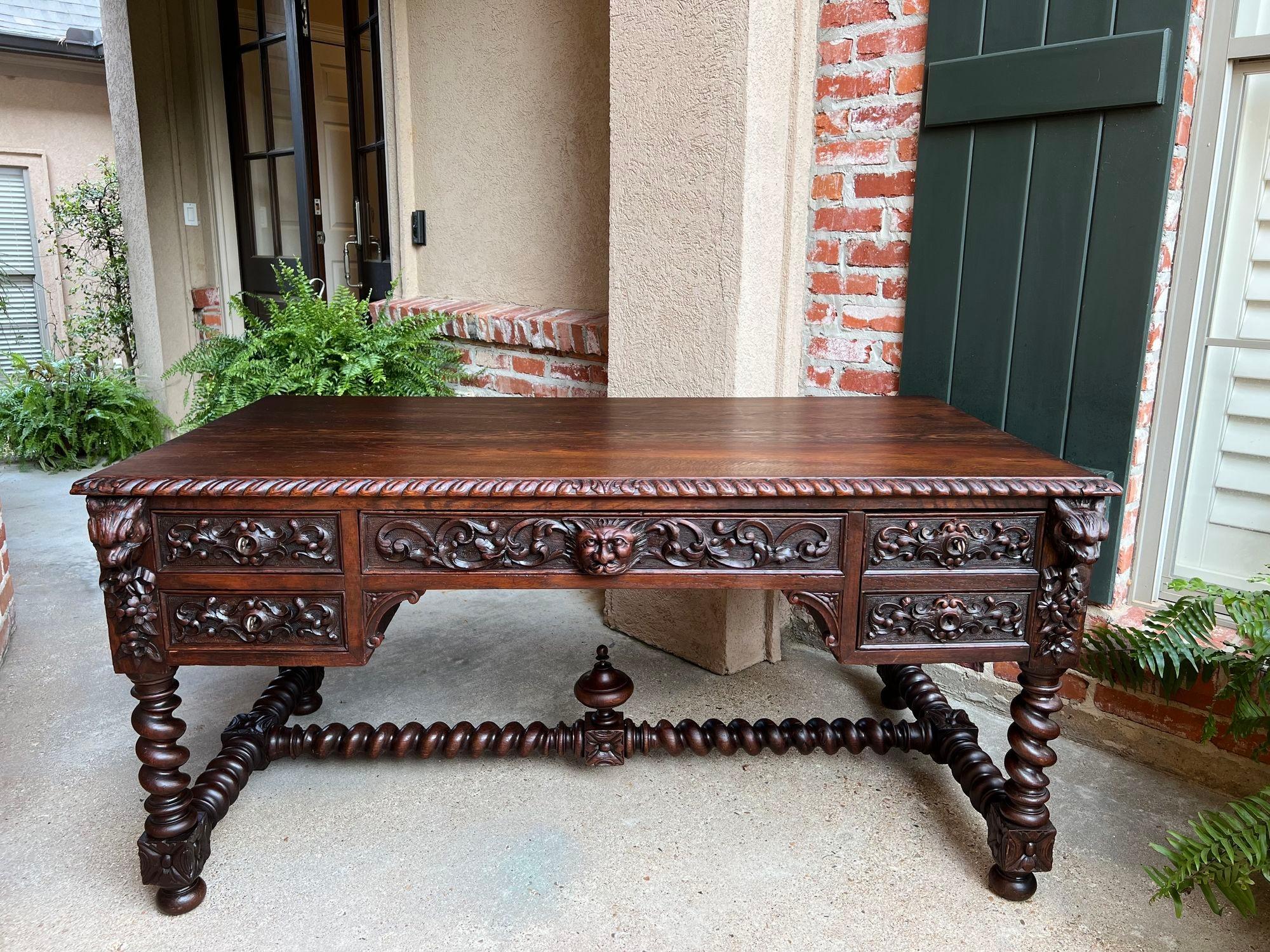 Antique French Renaissance Desk Carved Oak Barley Twist Office Library Table.

Direct from France, a stunning antique desk or library table, with a substantial 5. ft. size!
Opulent hand carvings include dimensional lion masks on the front corners