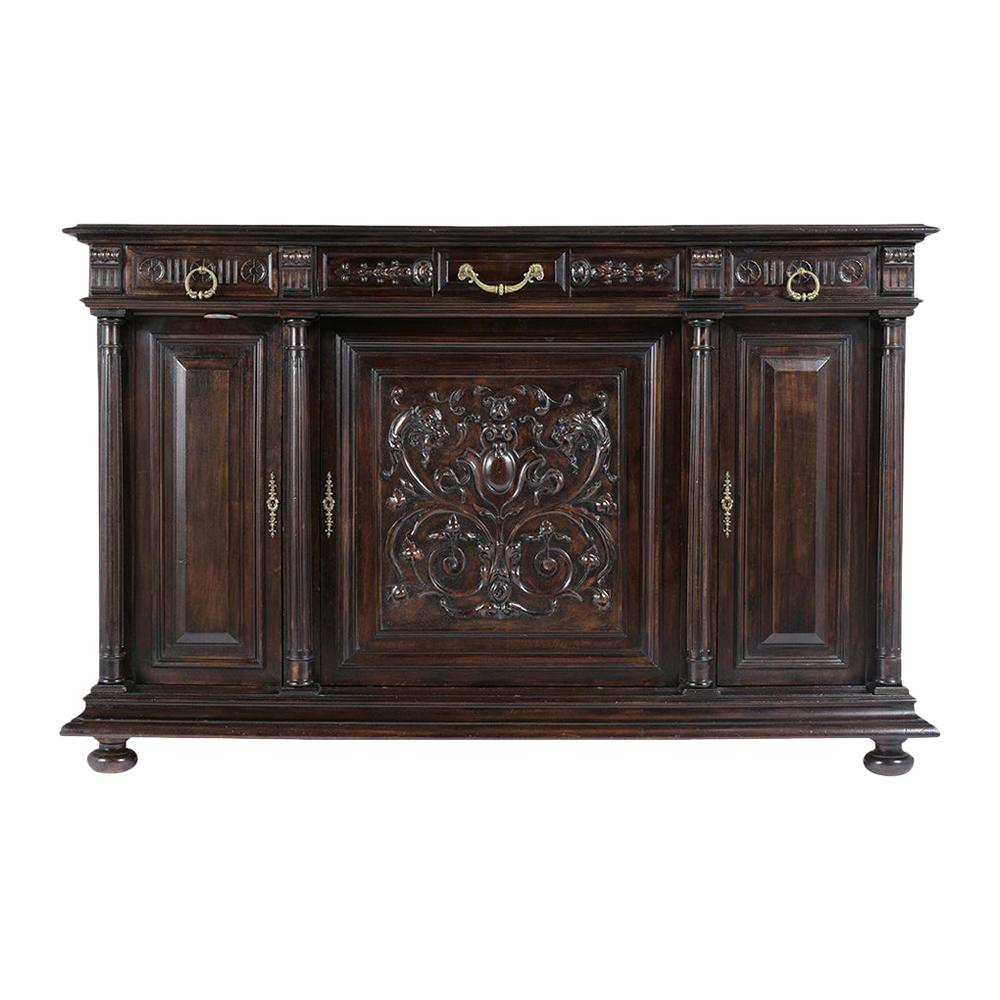 This French late 19th-century renaissance buffet is made out of walnut wood in great condition and has been newly restored by our in-house craftsmen. The credenza comes with finely hand-carved details, original ebonized color with a beautiful patina