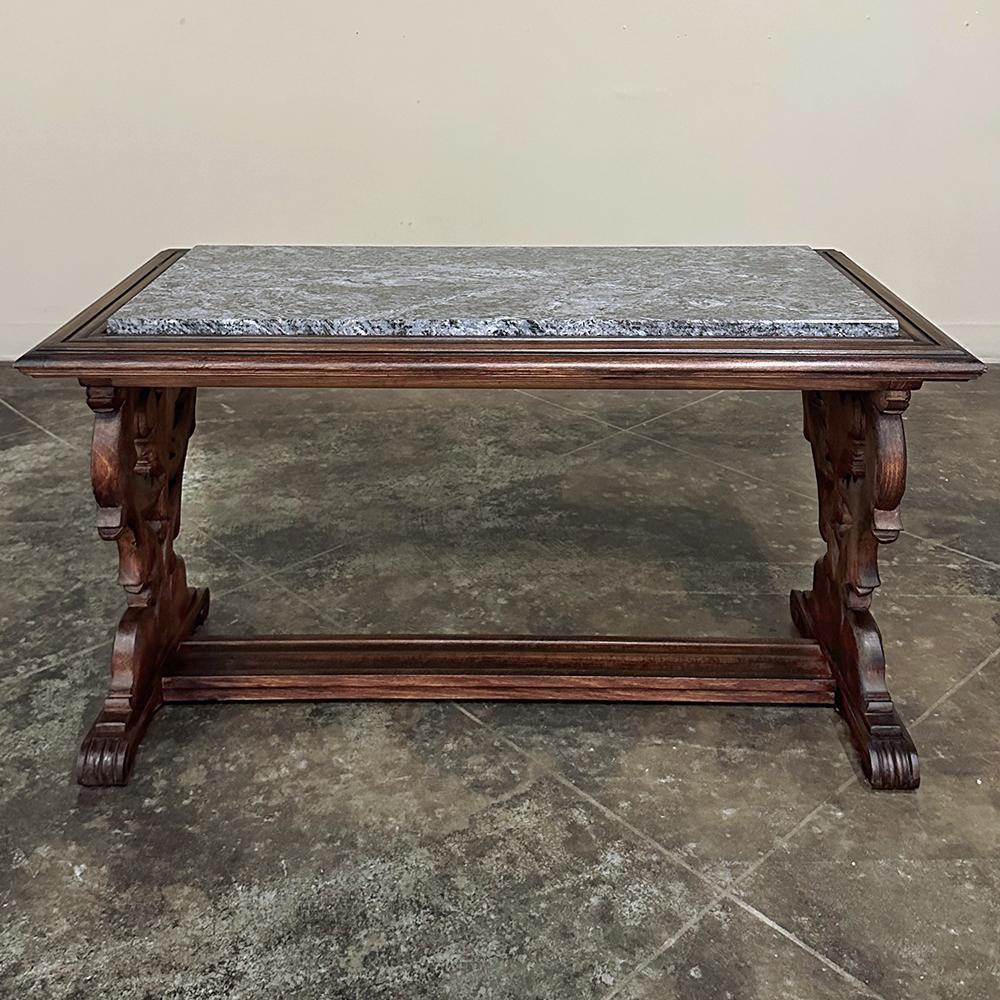 Antique French Renaissance Fruitwood Granite Top Coffee Table was beautifully sculpted from solid fruitwood that has been given a pleasing medium toned stain and finish.  The substantial framework that serves as the top surrounds a lovely piece of