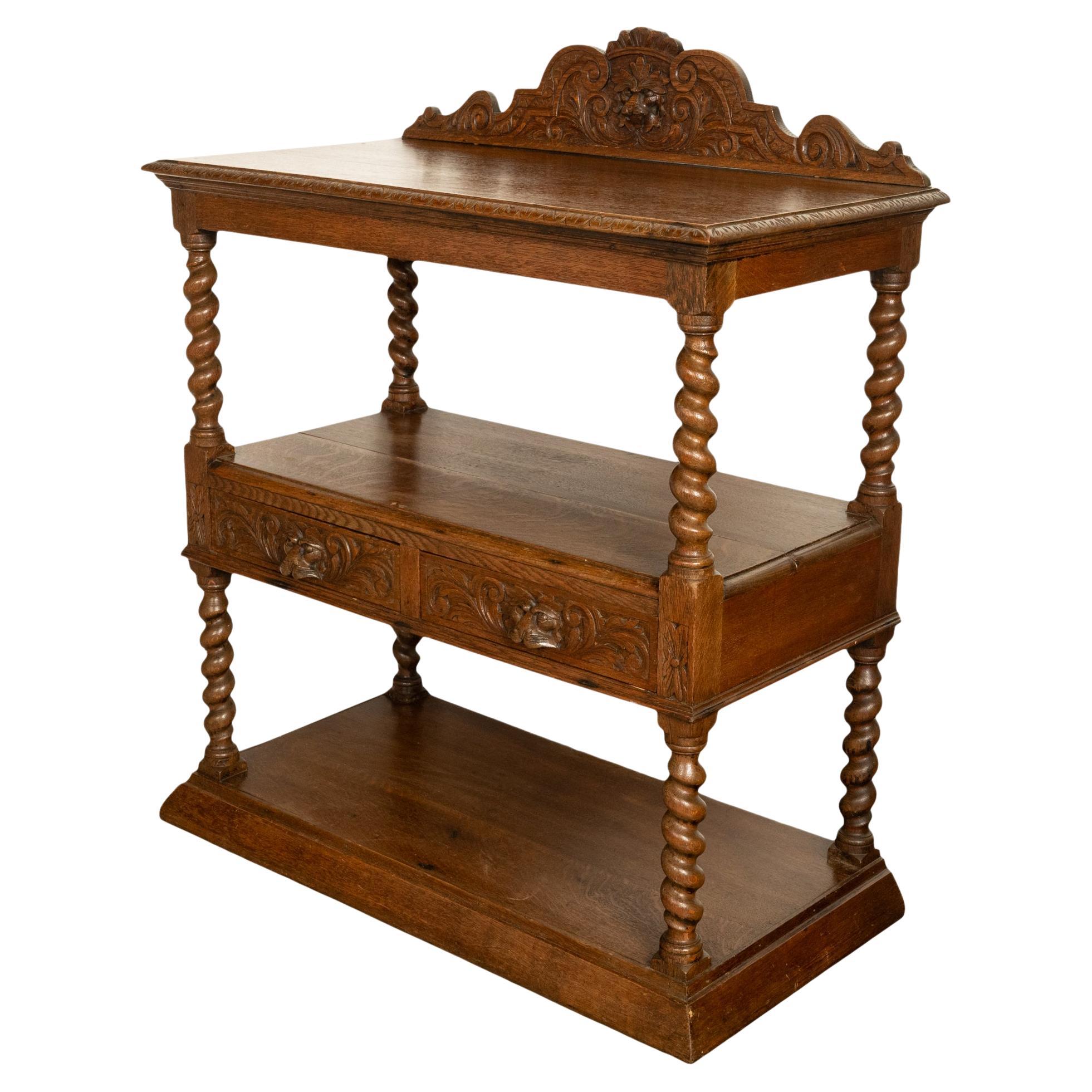 A very good antique carved oak French three tier buffet/server, circa 1870.
The back having a gallery carved with foliate & a lion's head crest, the top edge of the server carved with an a 'egg & dart' border. The three tiers are supported with