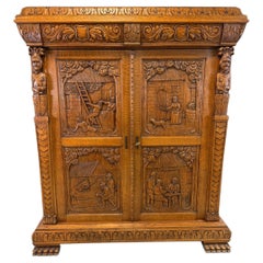 Antique French Renaissance Revival Carved Oak Cabinet with Figural Panels