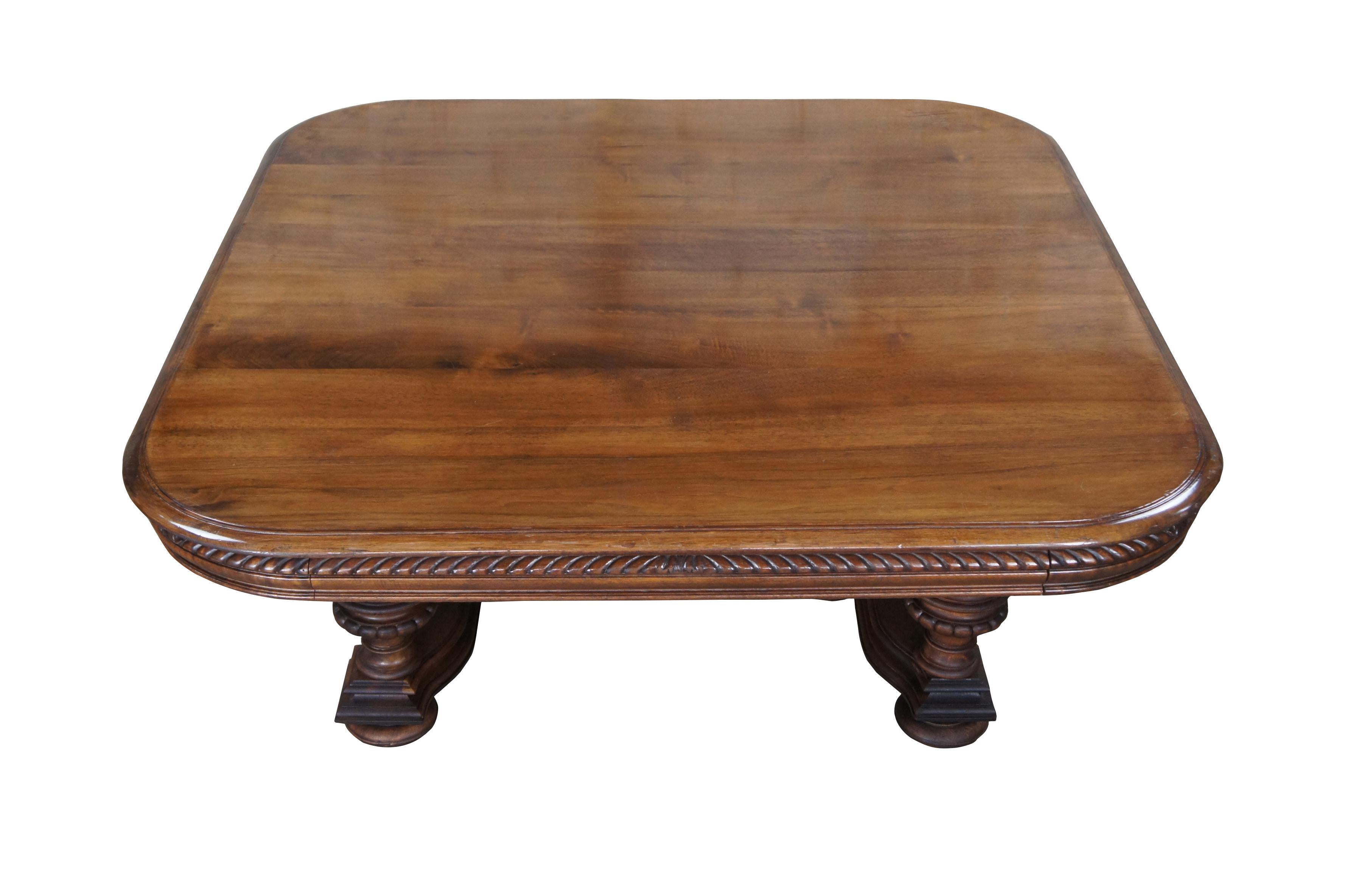 Early 20th Century French coffee table. A rectangular form made from walnut with contoured corners, a gadrooned edge and a unique trestle base consisting of baluster turned and fluted supports, spindled accents and bun feet. This remarkable table