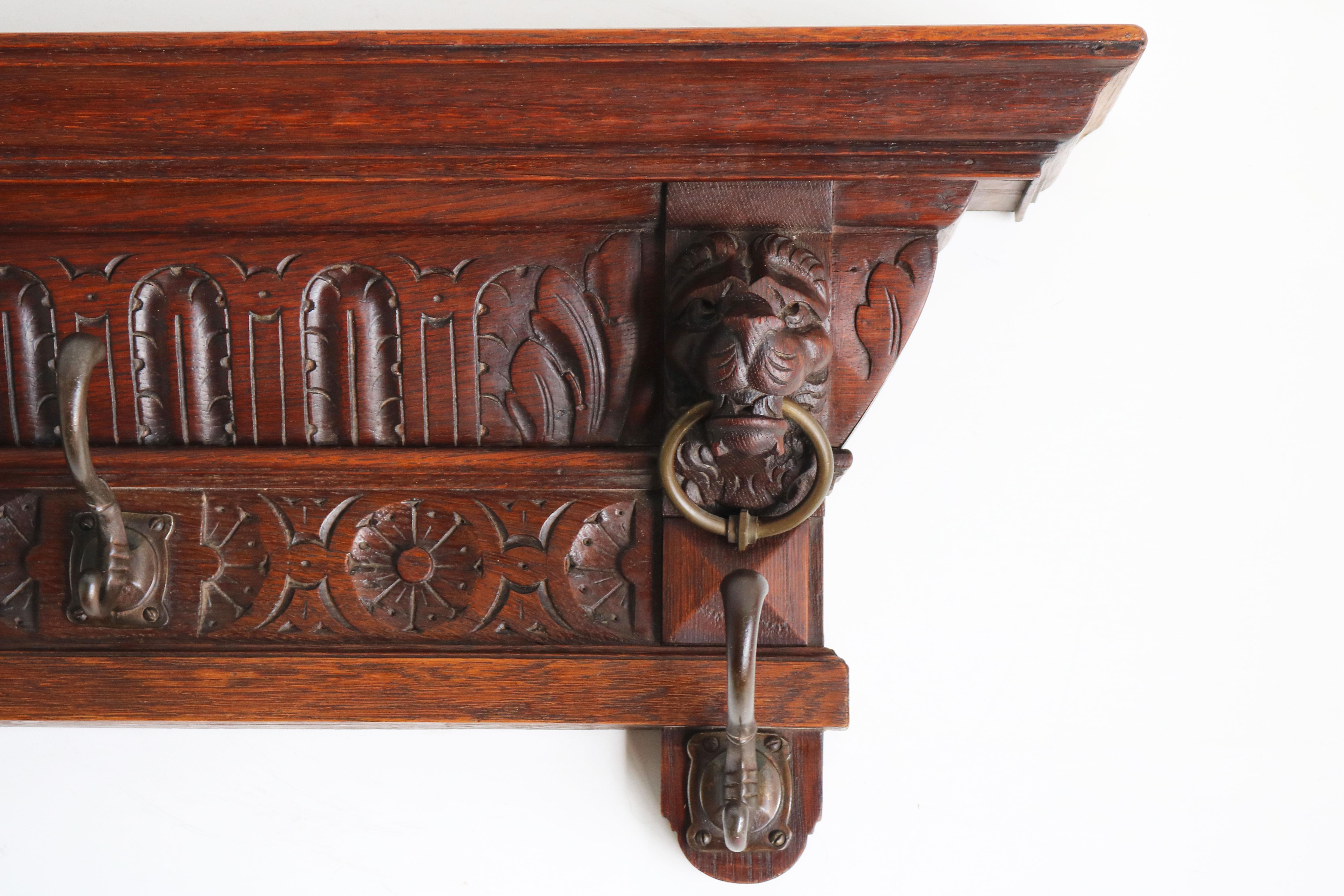Stunning antique French solid oak hand carved coat rack from the 1900s.
French Renaissance revival with symmetrical & highly detailed carvings and 2 impressive Lion heads holding brass rings.
The coatrack is in superb condition and well taken care
