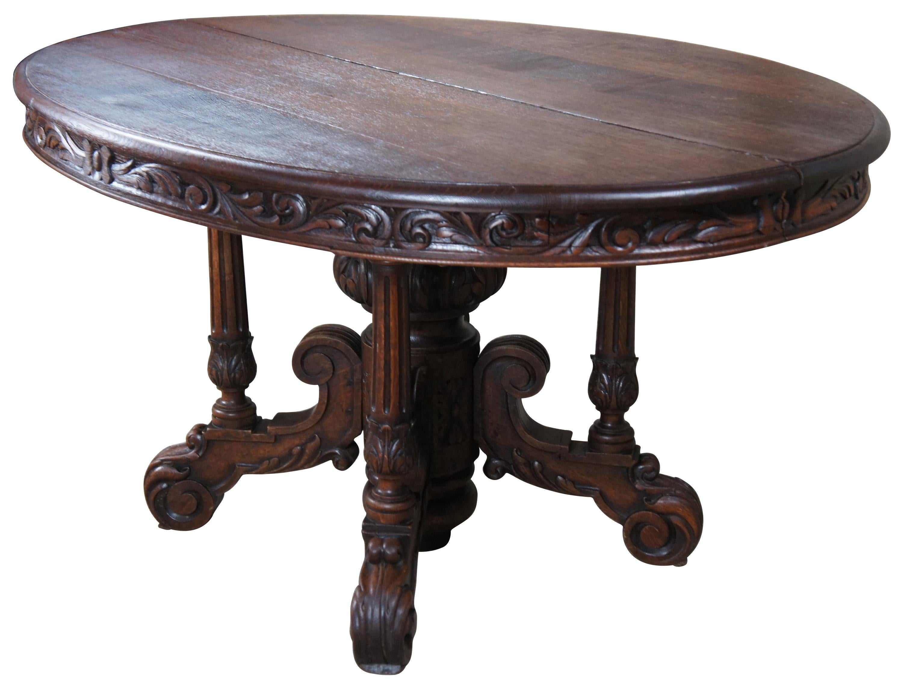 A lovely antique French Renaissance Revival dining or center (centre) table. Features an oval top with an ornately carved. The top is supported by an elaborate base with acanthus carved baluster support, flanked by hand turned and fluted columns