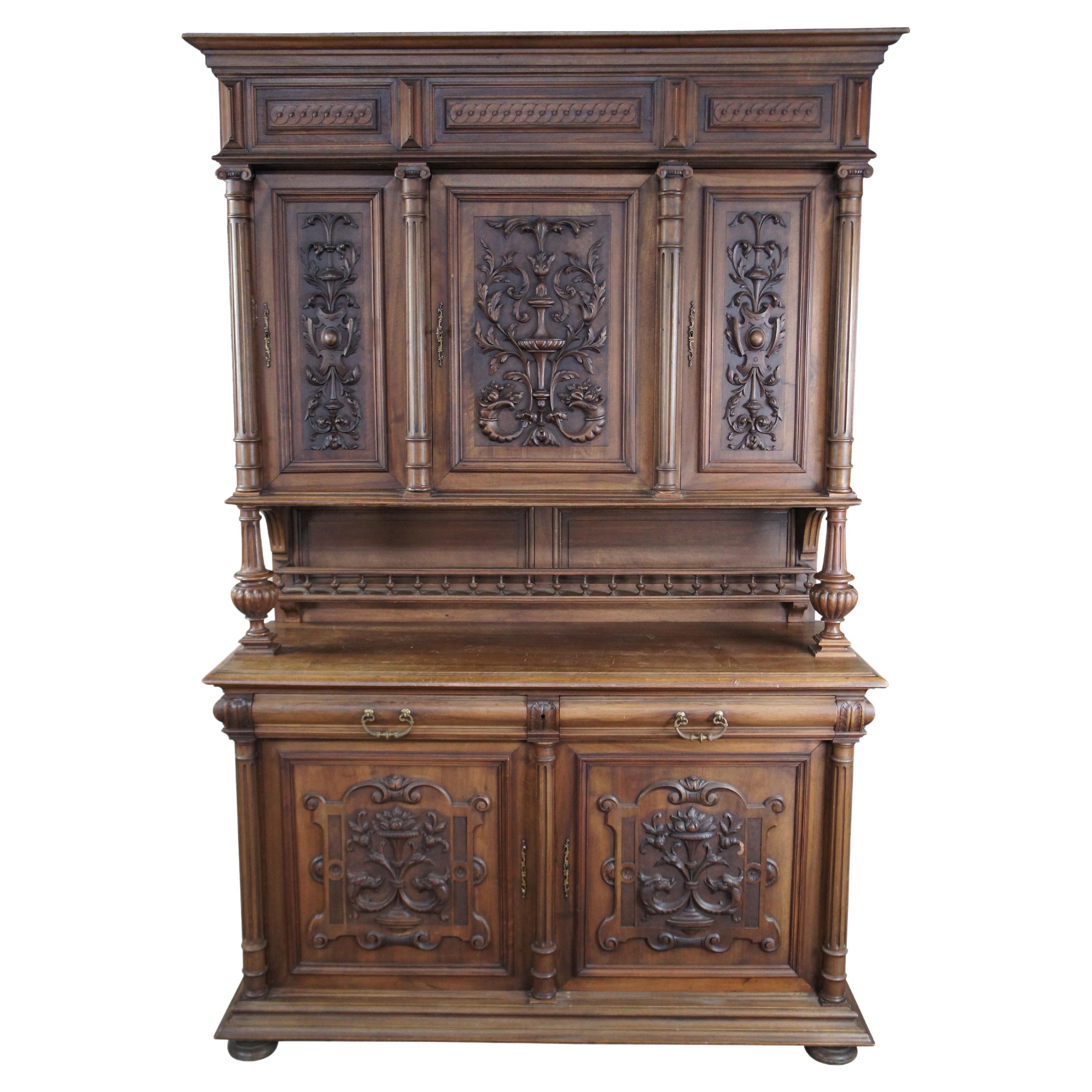 Antique French Renaissance / Henry II style walnut buffet a deux corps / vaisselier / cupboard / cabinet / hutch featuring Neoclassical carved figural / acanthus / floral theme.  The top of the cabinet features three cabinets with design of