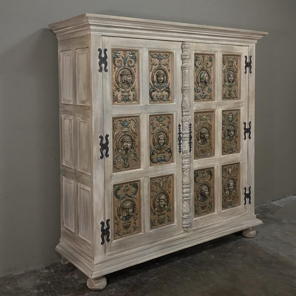 Antique French Renaissance Stripped Oak Armoire features no less than 12 individual relief carvings of busts of ancestors, all rendered in solid oak and framed in their own panels and mounted in the access doors separated by an intricately carved