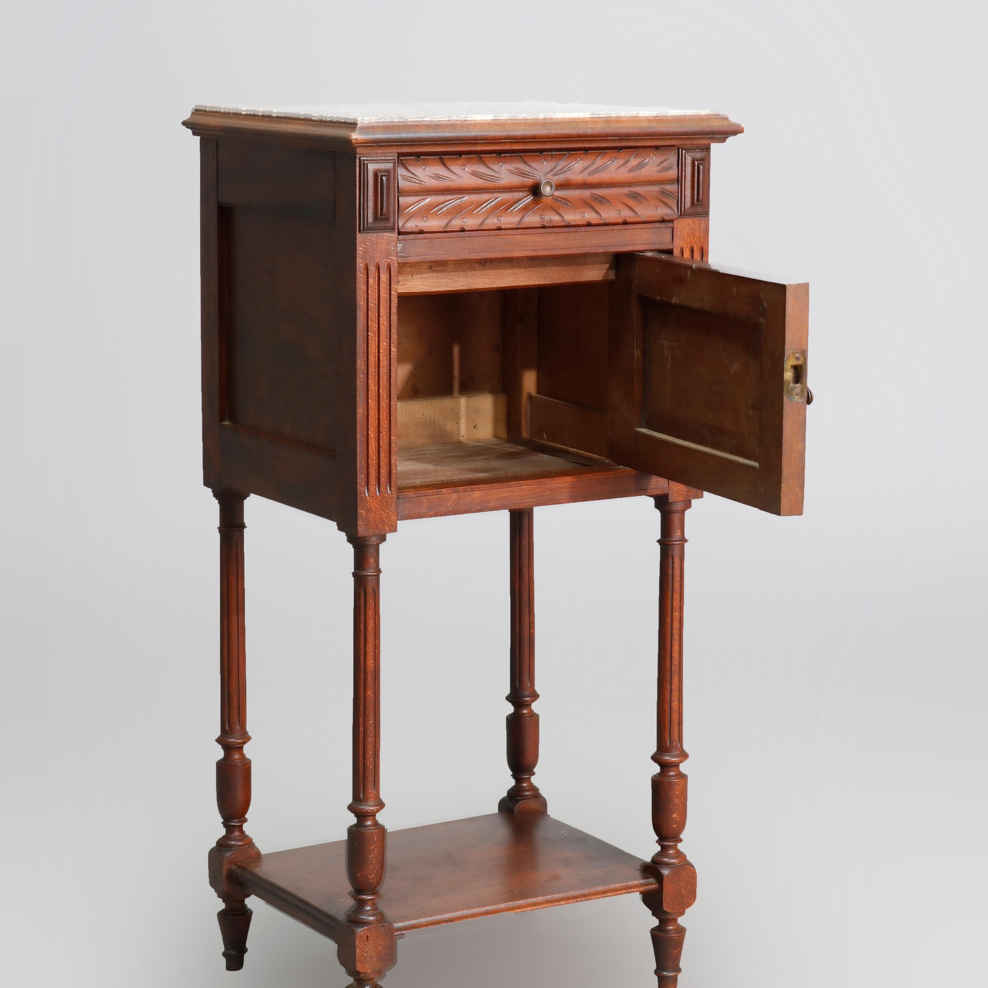 Vintage French Renaissance style stained pine side stand with inset marble-top over acanthus carved drawer with flanking pyramidal elements and single door cabinet with foliate carving, single lower shelf, raised on fluted tapered legs and feet,