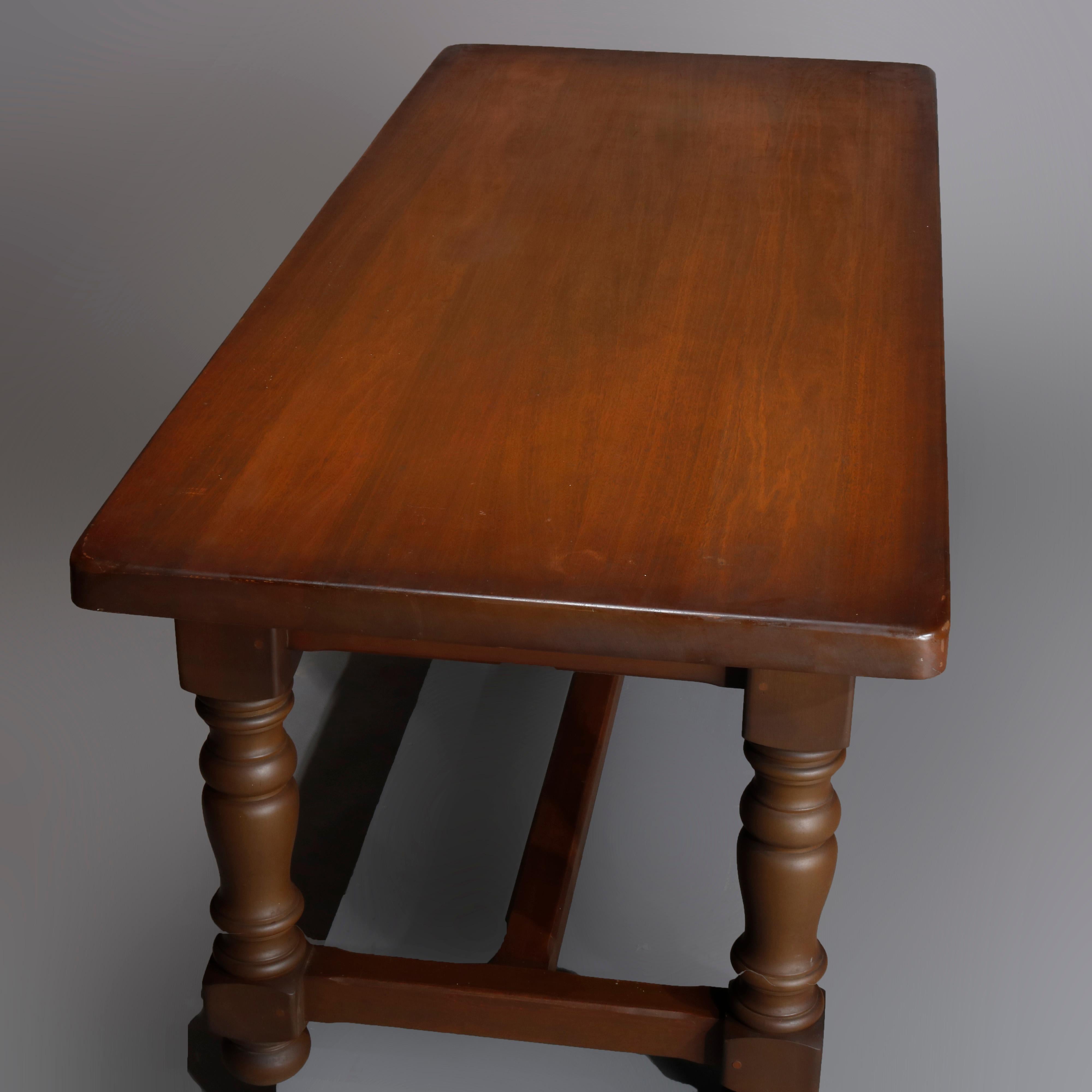 Antique French Renaissance style pine library conference table with block top having single drawer with pyramidal facing, raised on turned legs with H-stretcher, early 20th century.

Measures: 29.75