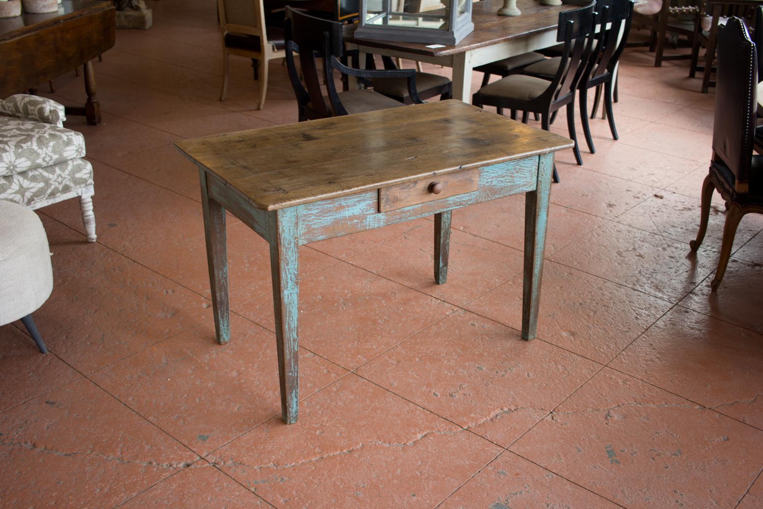 Antique French pine rent collector's desk on tapered legs with some paint still visible. The top has a 