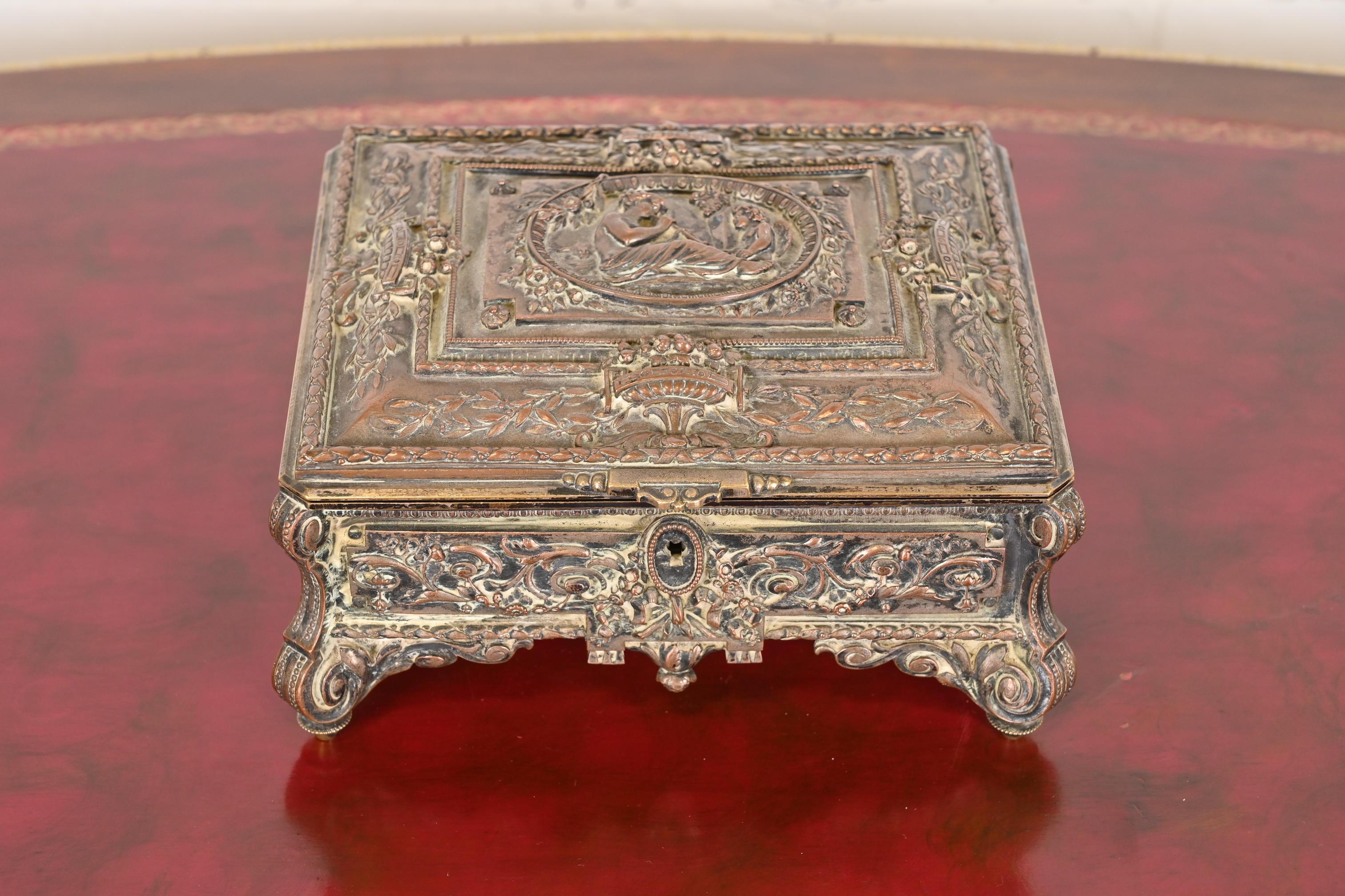 A gorgeous antique French Repousse dresser box, jewelry box, or decorative box

France, Circa Late 19th Century

Silver over bronze, with purple silk interior.

Measures: 7.75