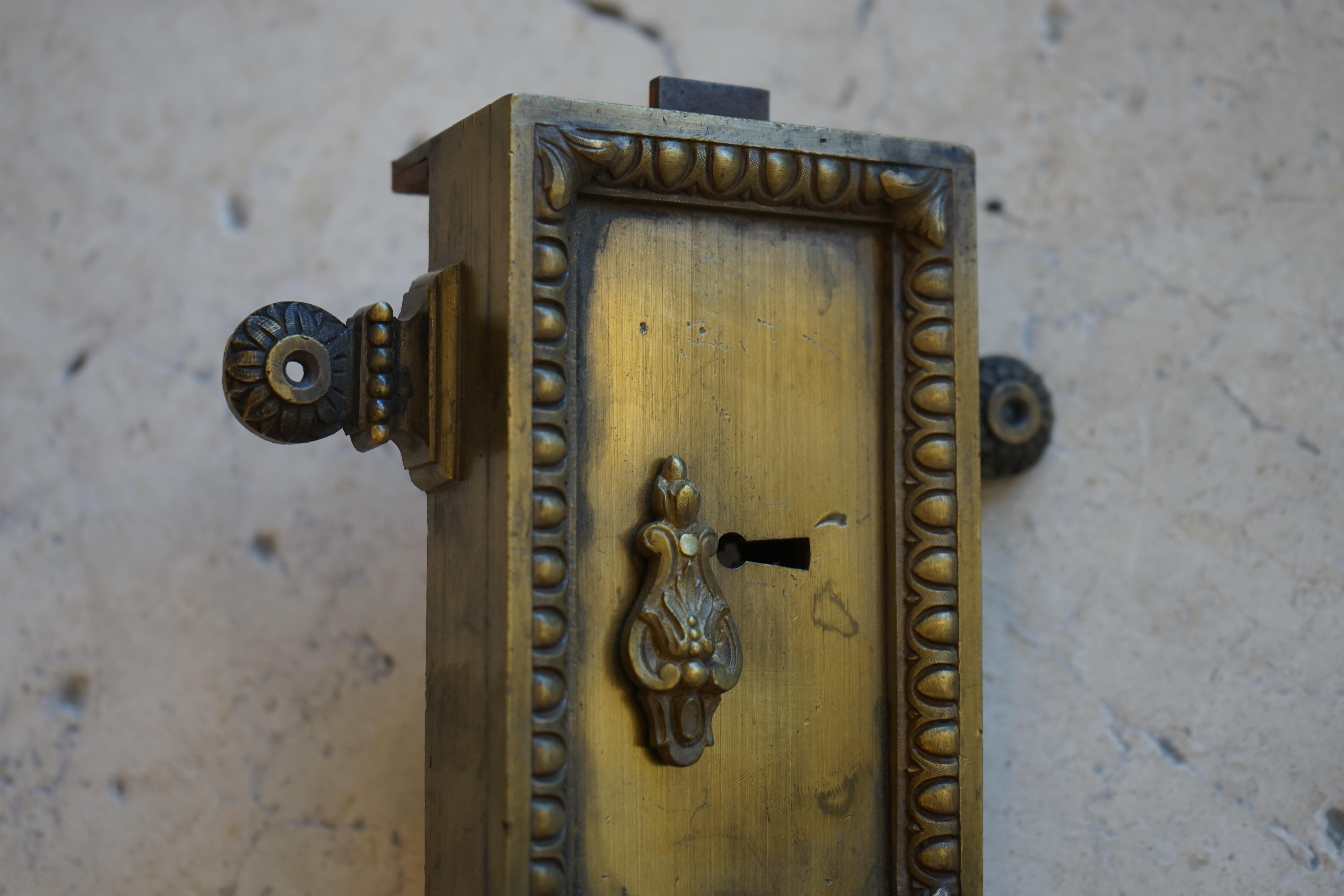 This antique hardware piece is made for use as a rim lock. 

Measurements: 8'' L x 6'' H x 1.25'' D.