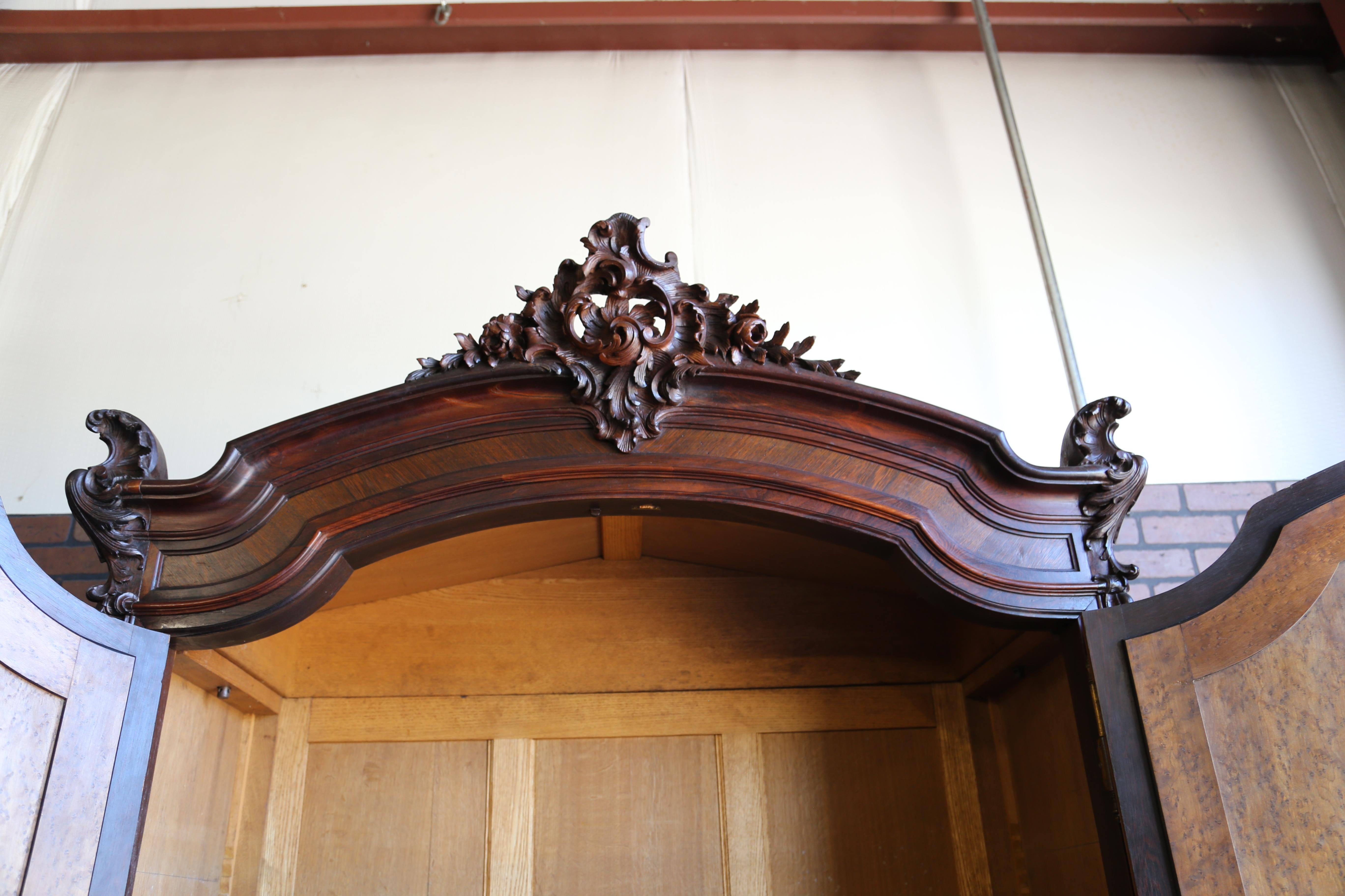 Magnificent Antique French Louis XV Rococo Armoire. This cabinet is in remarkable condition considering its considerable age. Imported from Europe featuring exquisite carved details including a pediment, the corners of the top, on the mirror door