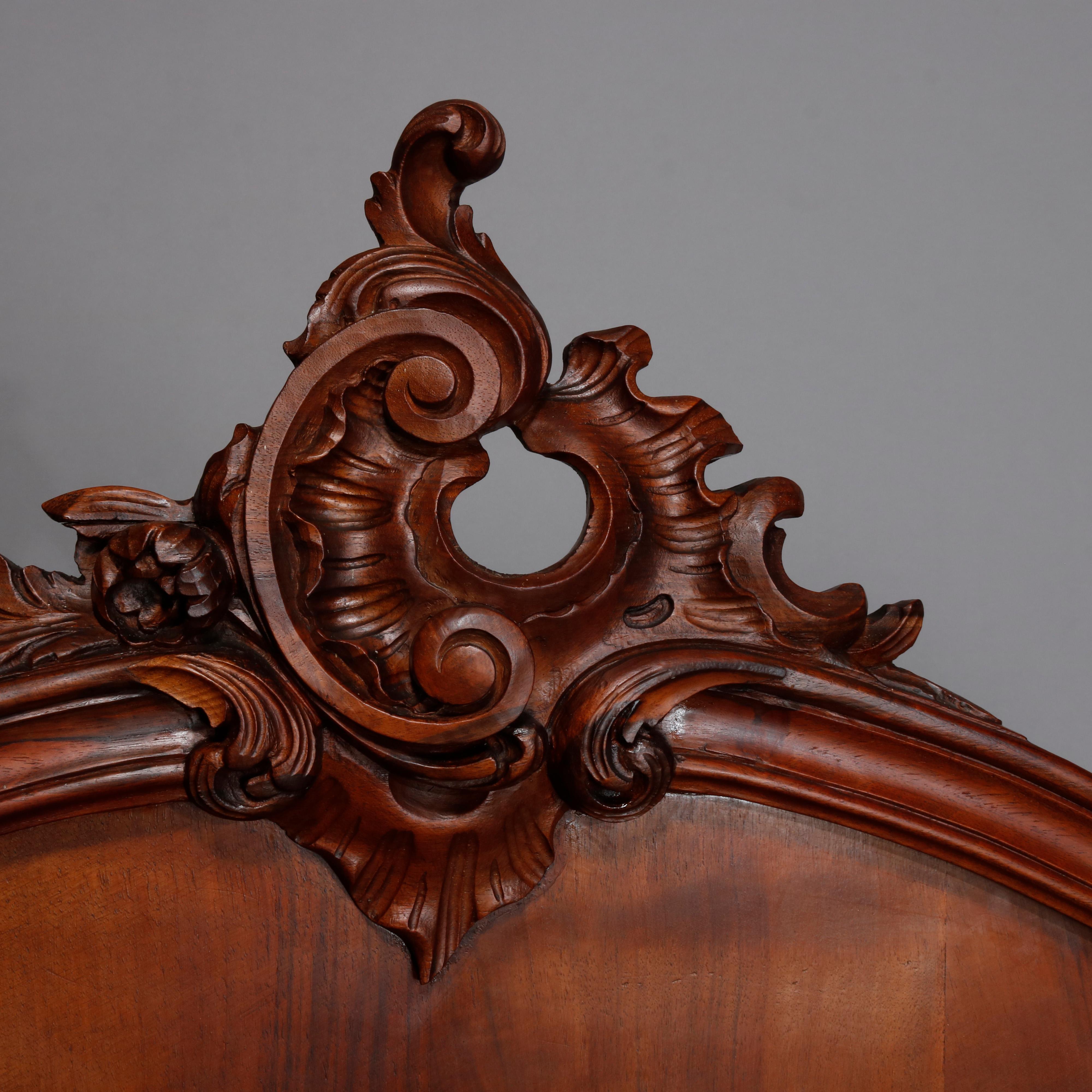 French rococo carved flame mahogany full bed frame with scroll and foliate cartouche over shaped headboard with cabriole legs having acanthus knees and scroll feet, shaped side rails, early 20th century.

Measures- Headboard- 58.5