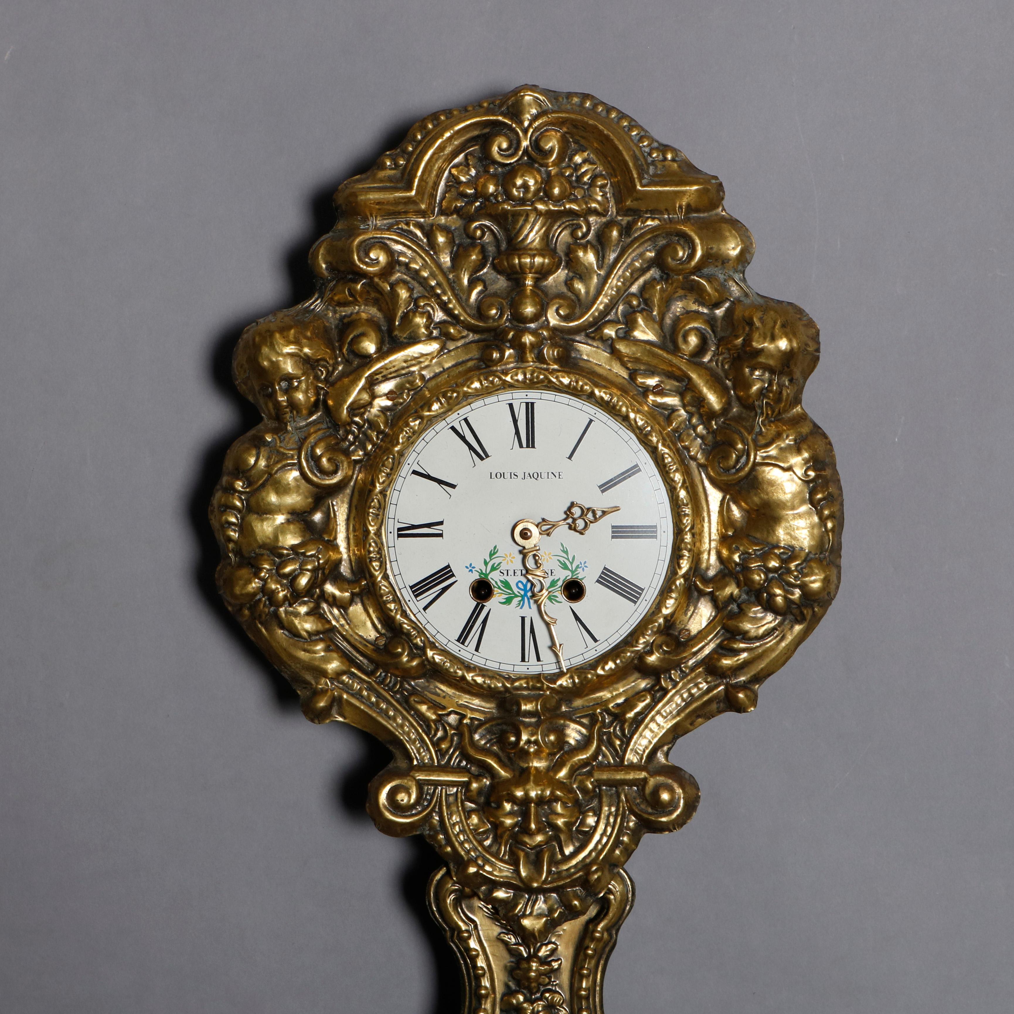 An antique French Rococo Comtoise, Wag-on-Wall, clock offers brass relief case and pendulum with upper having urn and foliate decoration surmounting enameled face with Roman numerals and signed Louis Jaquin, St Etienne, flanking figural cherubs and