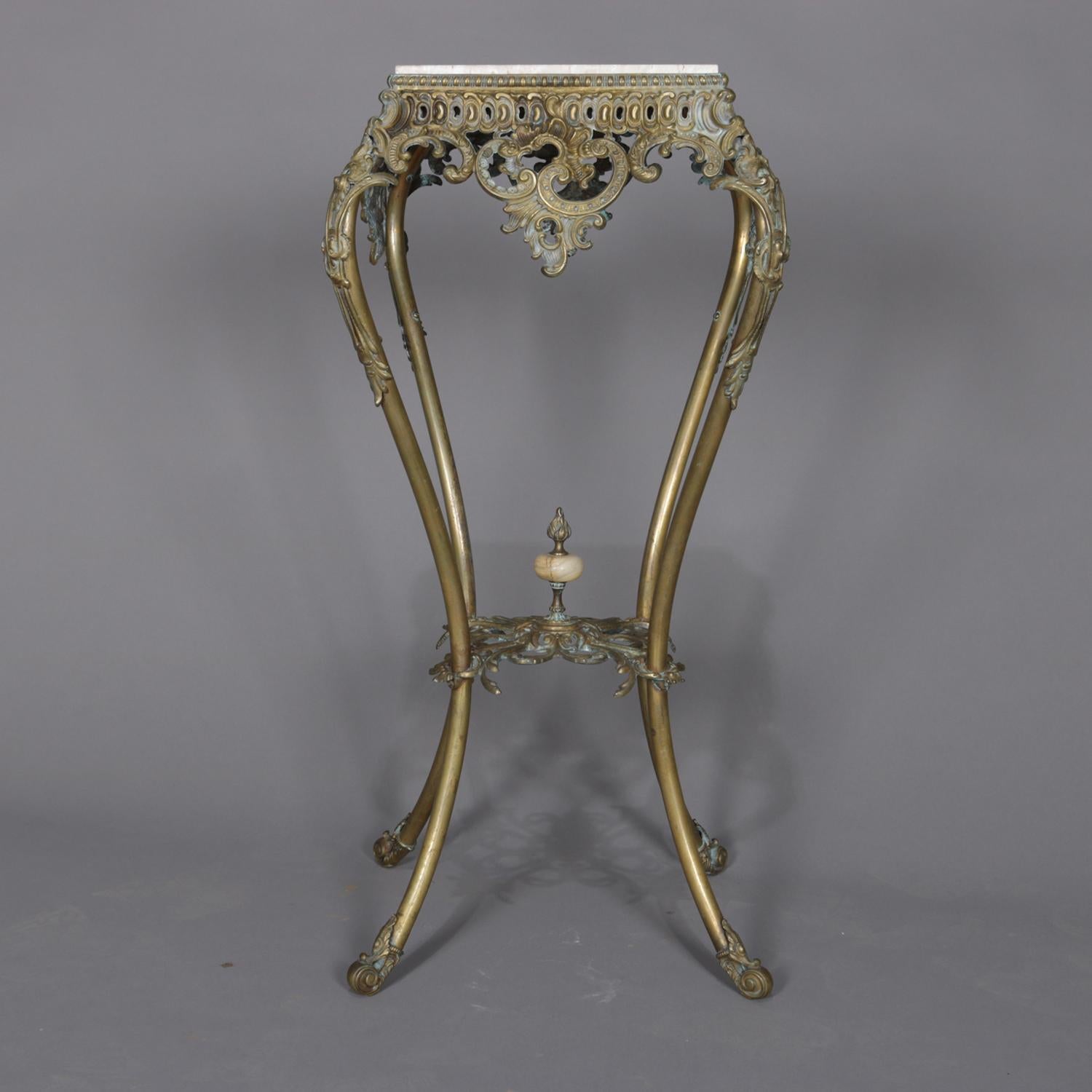 An antique French Rococo plant stand features gilt bronze base with pierced scroll and foliate apron and cabriole legs terminating in scroll feet and surmounted by faux marble tile top, circa 1890.

Measures: 33.5