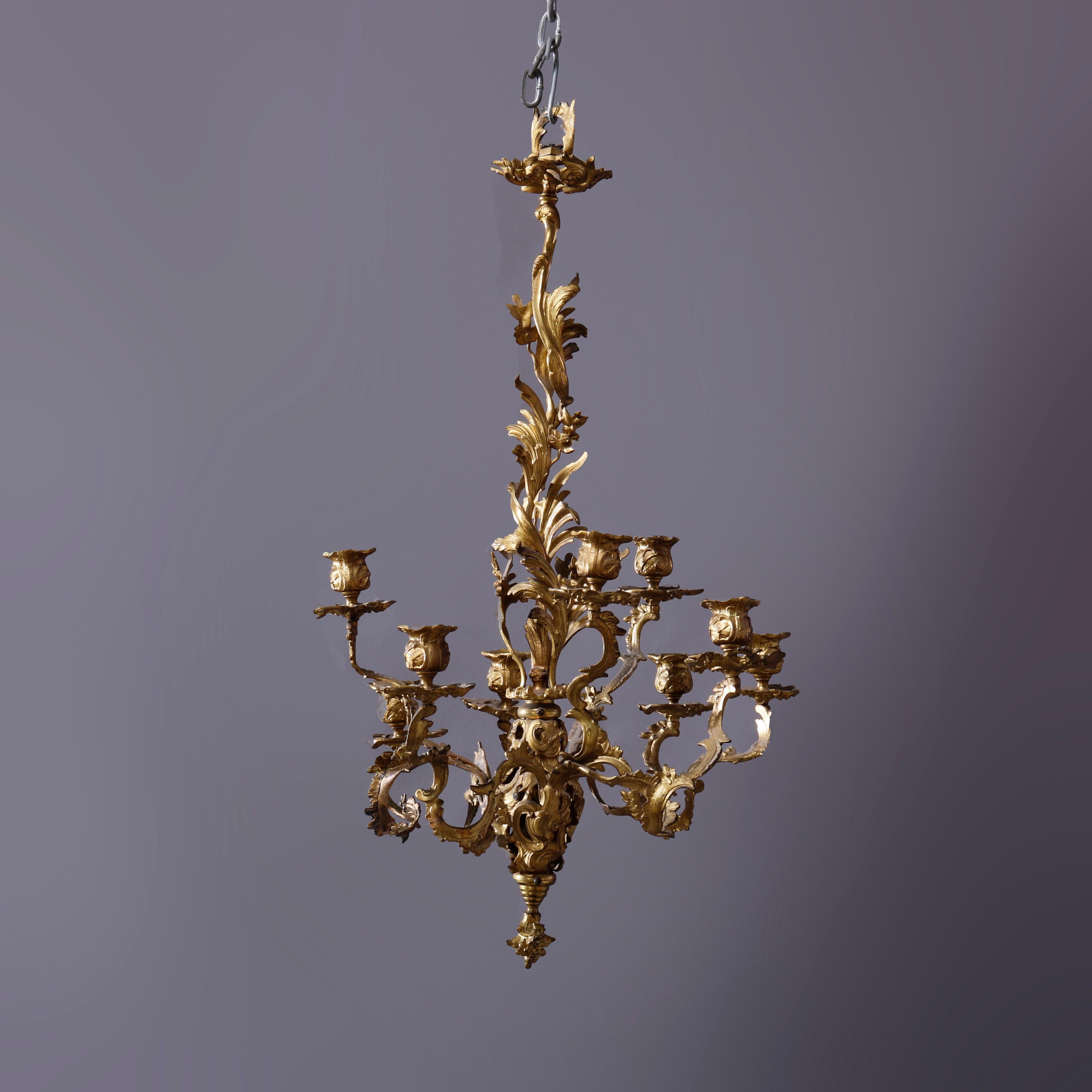 An antique French Louis XIV into Rococo hanging candelabra chandelier offers cast gilt bronze frame in the form of scrolled foliate elements with acanthus arms terminating in candle sockets, c1890

Measures - 28''H x 13.5''W x 13.5''D.