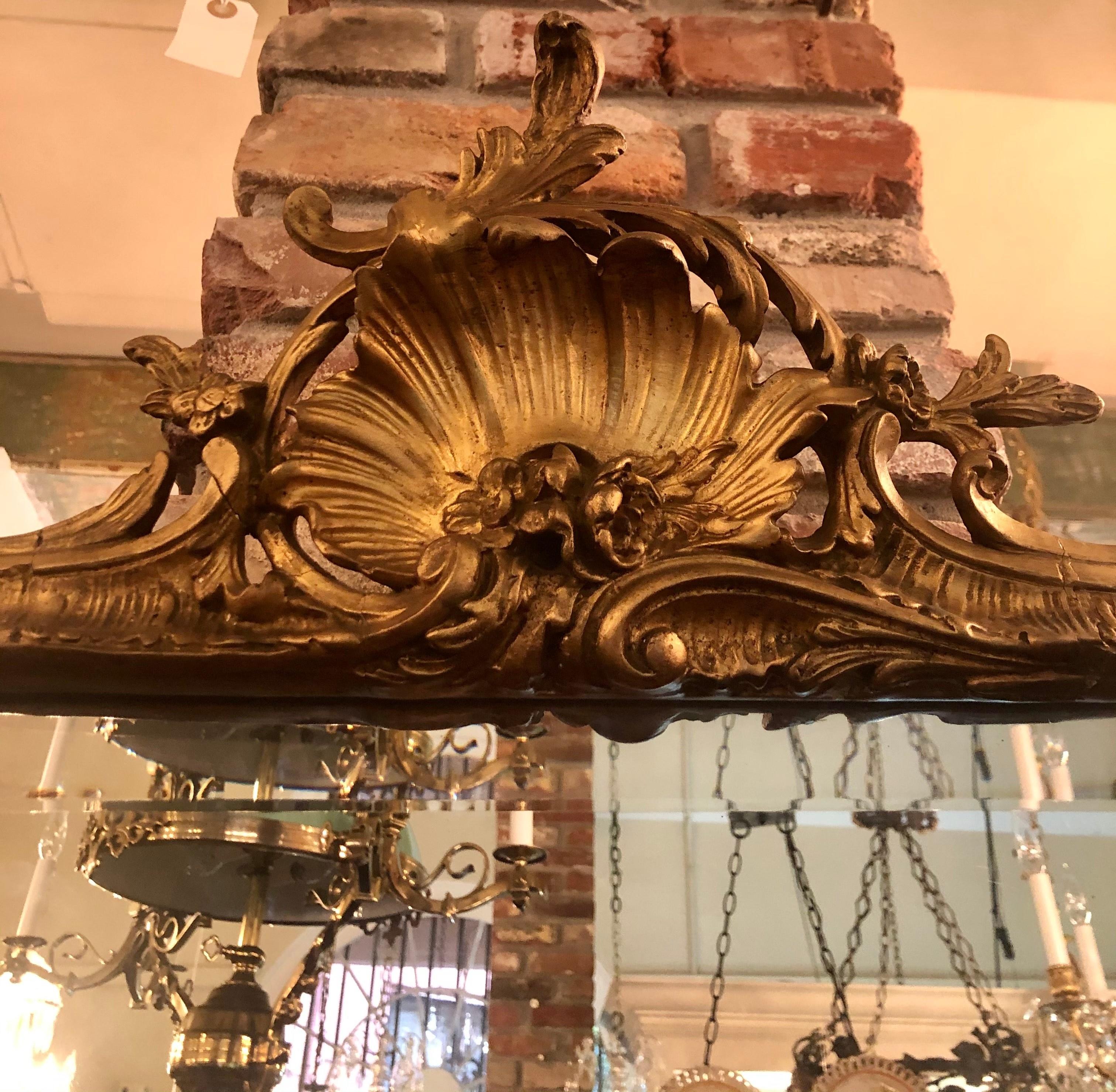 Antique French Rococo style carved gilt wood beveled mirror, Circa 1890-1900.