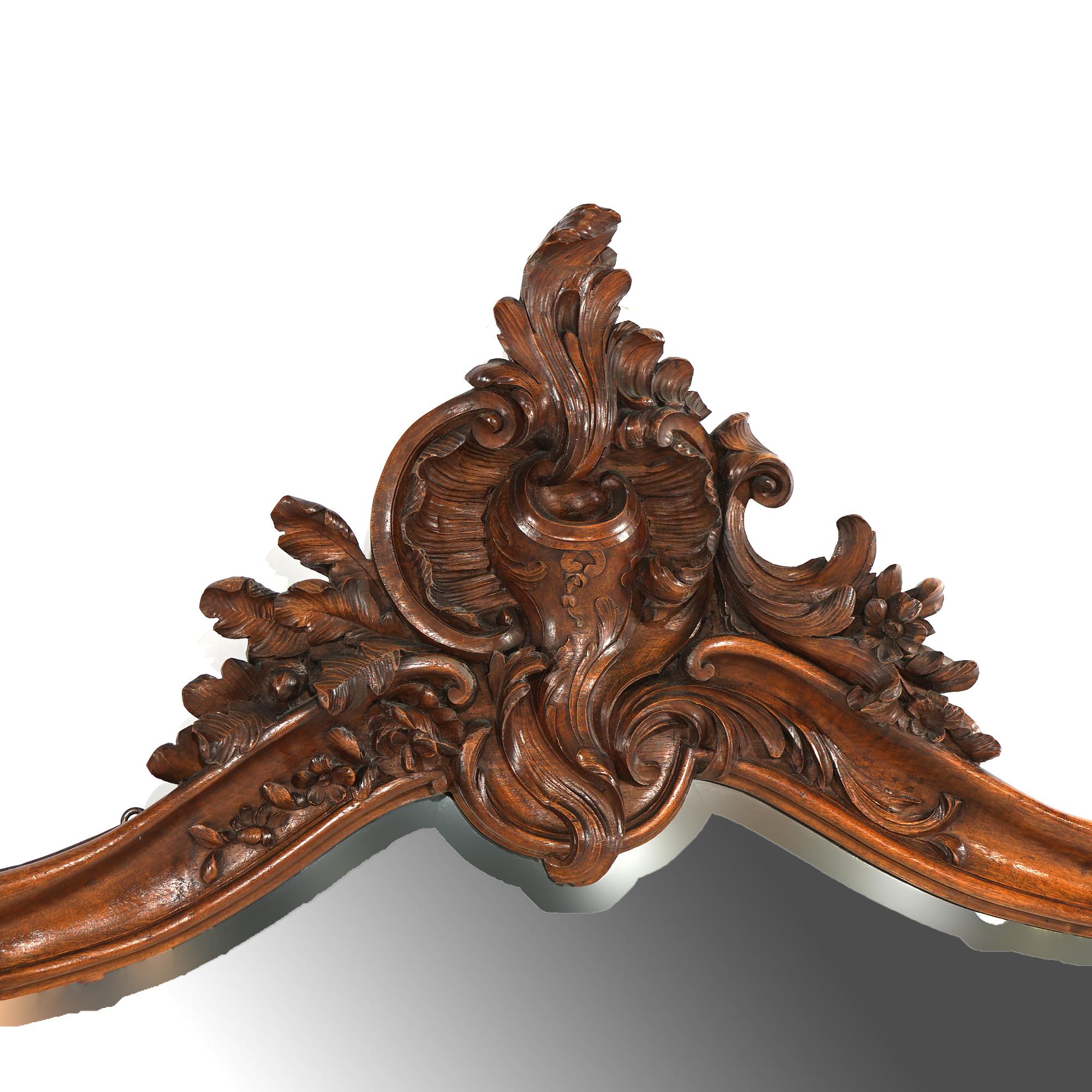 ***Ask About Discounted In-House Shipping***
An antique French Rococo style console offers oversized mirror having mahogany frame with carved cartouche, gadroon and foliate elements; matching marble top table raised on cabriole legs,