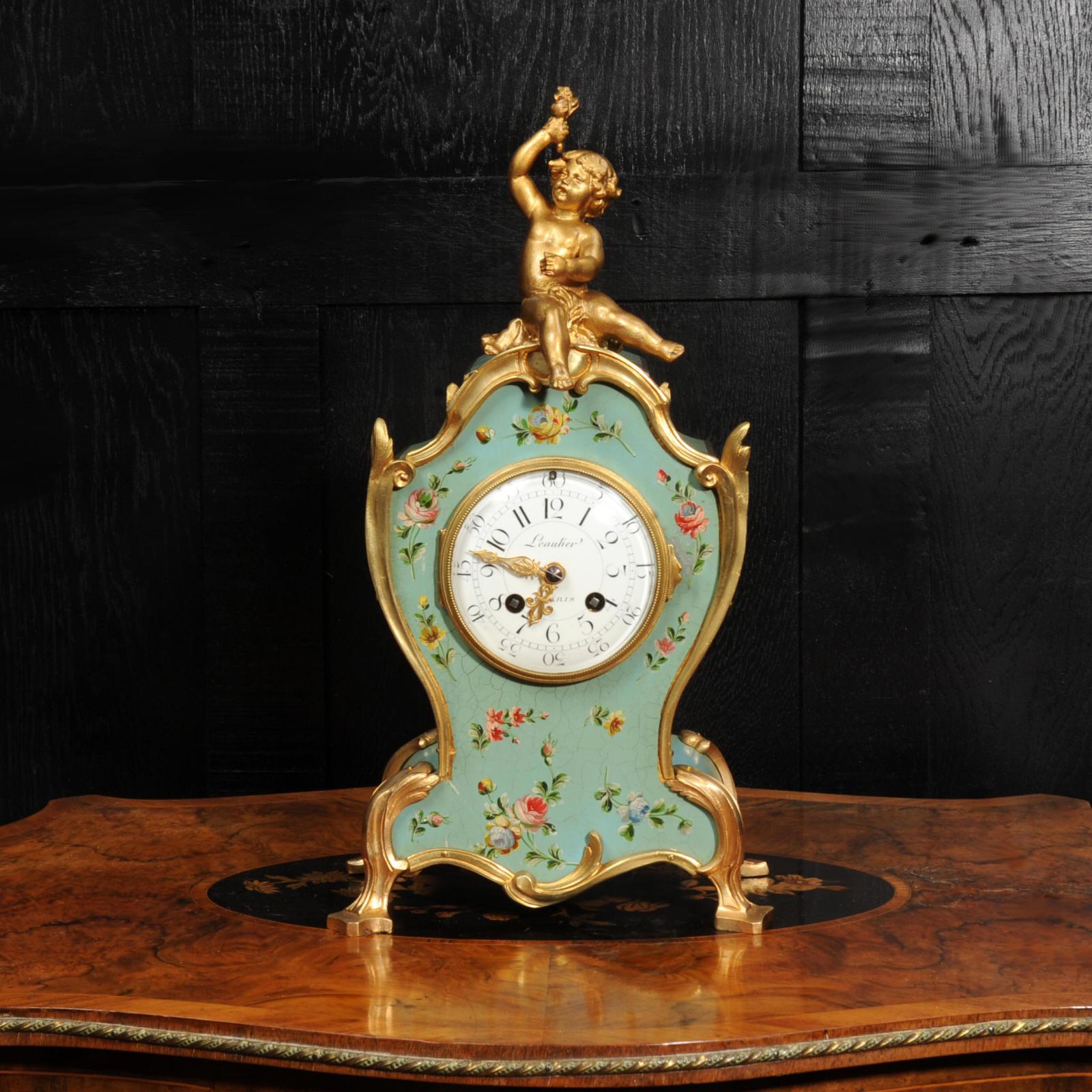 A stunning antique French Vernis Martin style lacquer clock, Circa 1890. The exquisite waisted, lacquered eau de nil case is decorated with delicate floral swags and mounted with gilt bronze. The gilt metal cherub sits aloft, offering a bouquet of