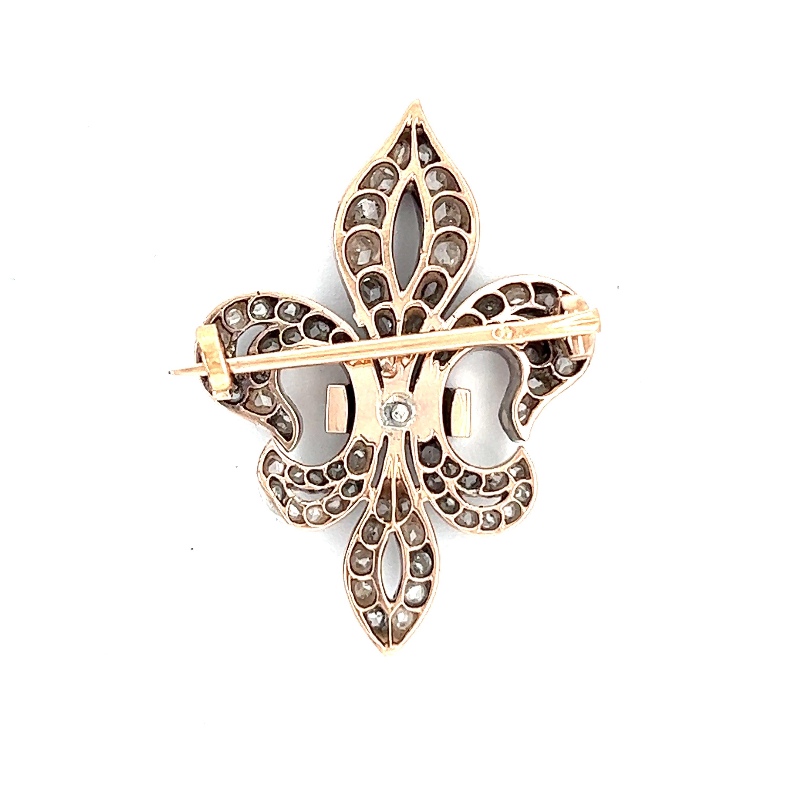 One Antique French Rose Cut Diamond 18 Karat Gold Fleur de Lis Brooch. Featuring 75 rose cut diamonds with a total weight of approximately 2.40 carats, graded G-H color, SI clarity. Crafted in 18 karat rose gold topped with silver, with French