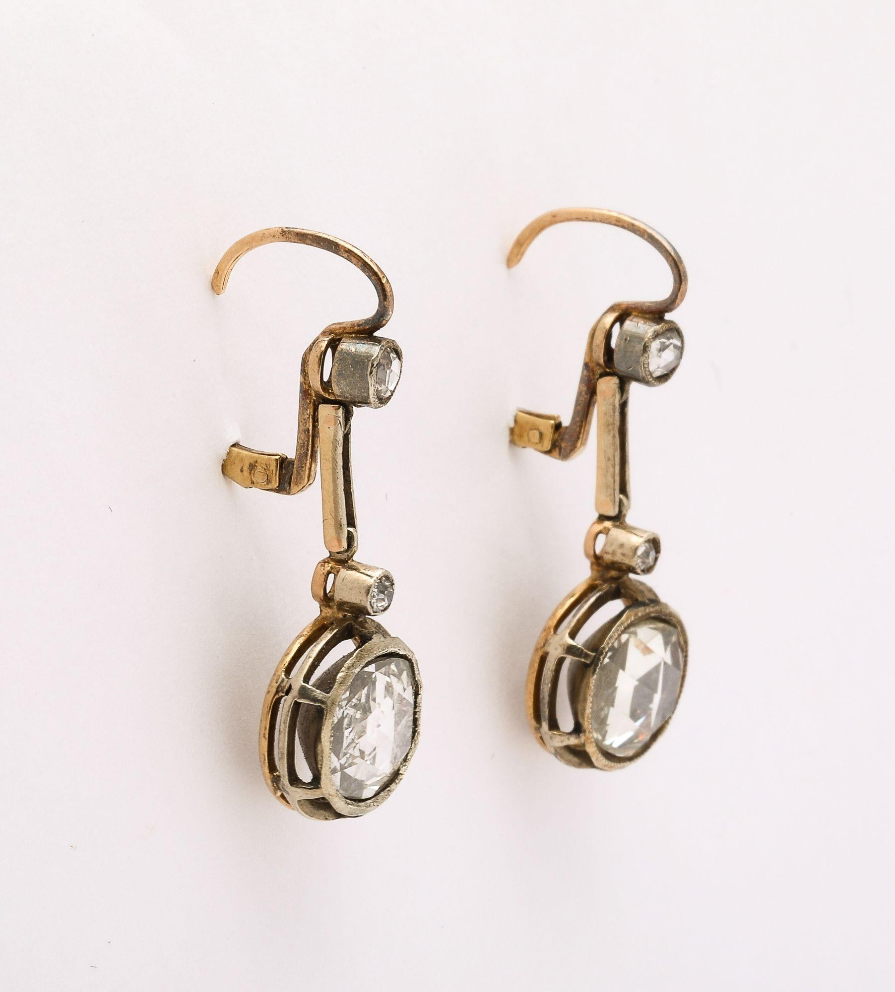 A stunning significant pair of Antique French Rose Cut Diamond Dangle Earrings. Large antique stones capped with smaller rose cut diamonds set in gold