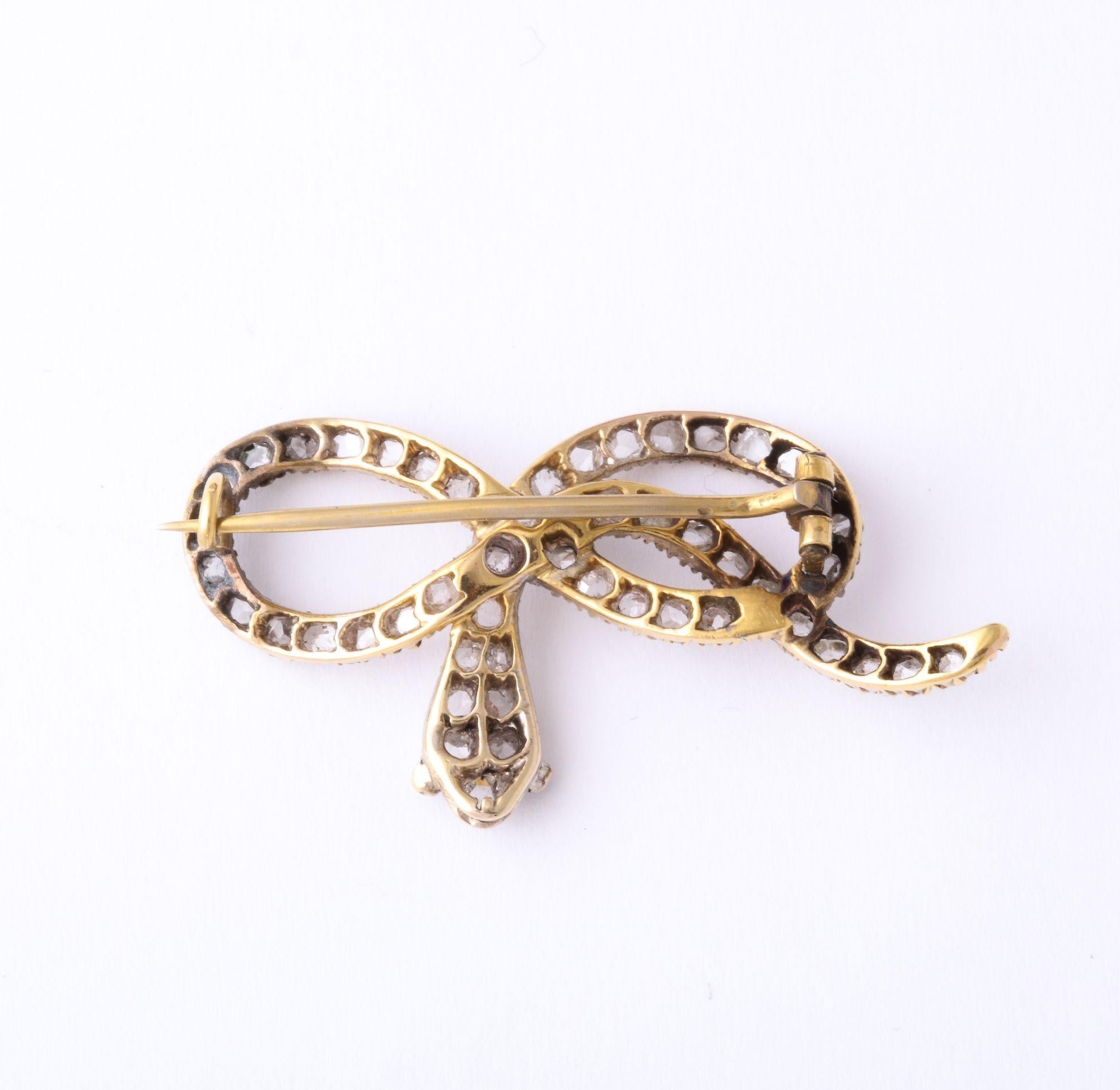 A great French Antique 'Victorian' Rose Diamond 'Infinity' Snake Brooch in 18k Gold with ruby eyes.