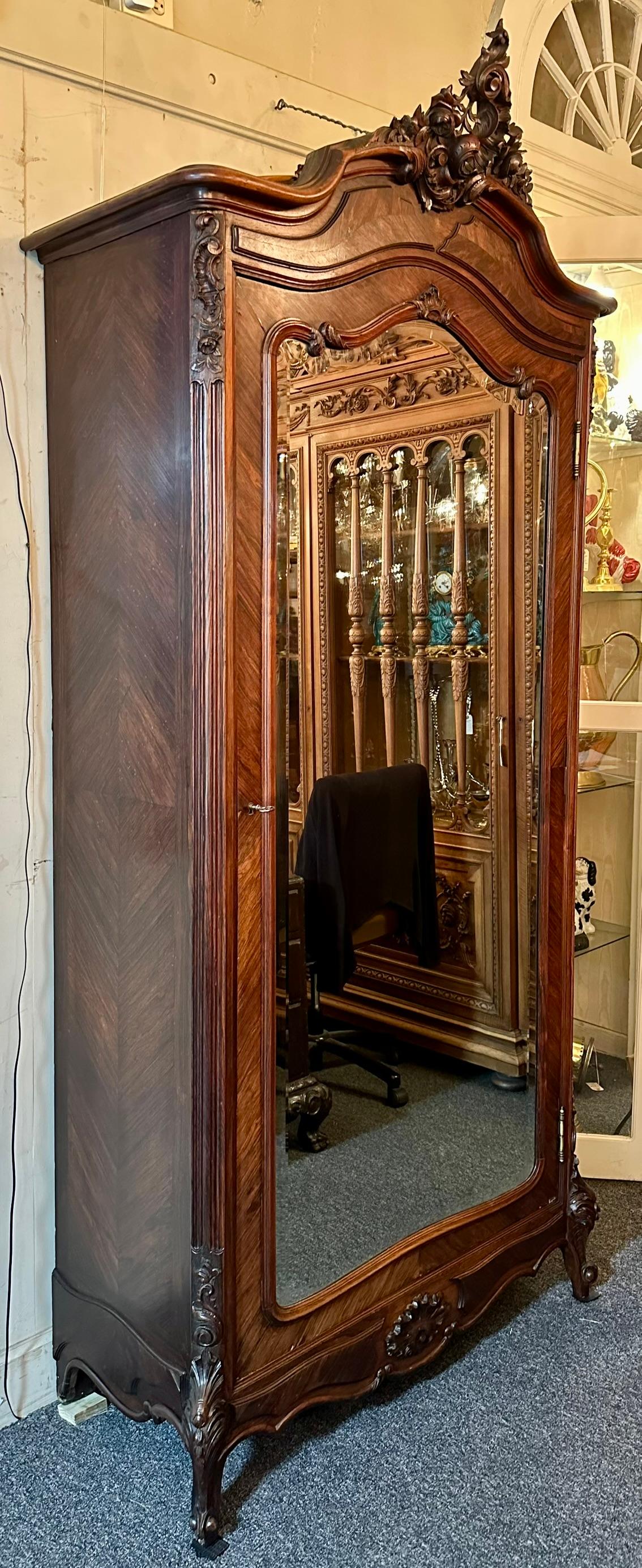 Antique French Rosewood and Beveled Mirror Single Door Armoire, Circa 1890-1900.
This armoire has 4 removeable shelves and a fitted drawer at the bottom.  The tops and fronts of the shelves are finished, bottom unfinished, and the interior of the