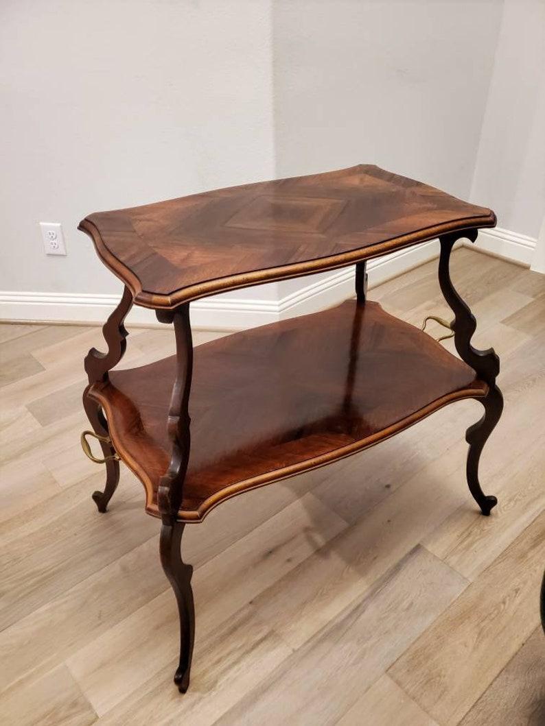 An exquisite French rosewood dessert serving tray table dating to the turn of late 19th / early 20th century. Finished in sophisticated Louis XVI style, nicely curved lines give this piece the most elegant silhouette, solid wood construction, having