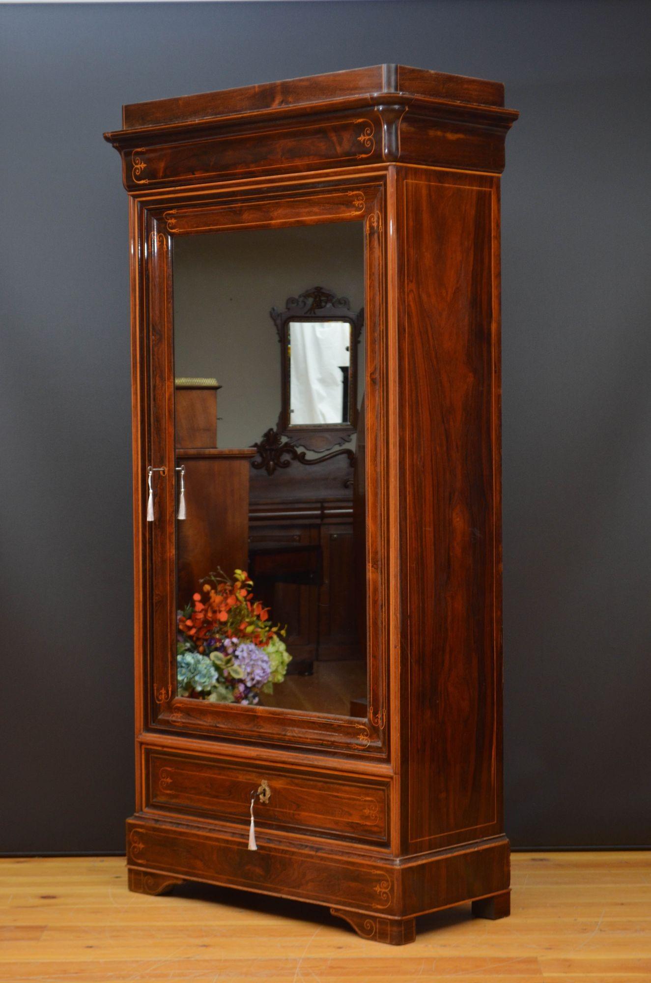 Sn5550 Fine quality and very attractive XIXth century rosewood bookcase or wardrobe having outswept cornice with string inlaid frieze and a mirrored door in inlaid frame with original working lock and key, enclosing four height adjustable shelves,