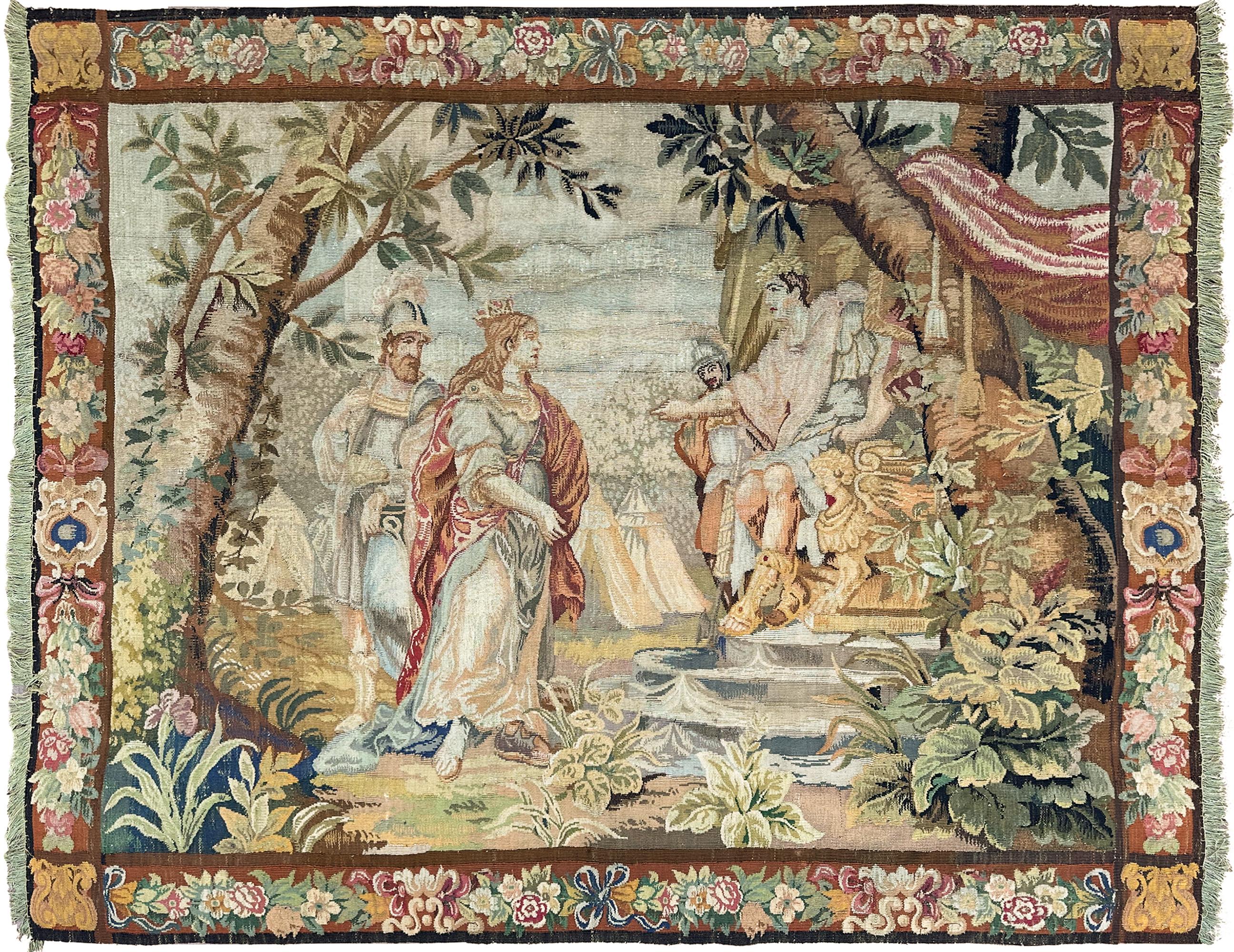 This 1890 Antique French Tapestry Royalty 213x244cm Queen Boudica 7x8 Royale Theme showcases an elegant late-19th-century French tapestry depicting a royal court narrative with finely rendered figures, lush foliage, and ornate floral borders. The