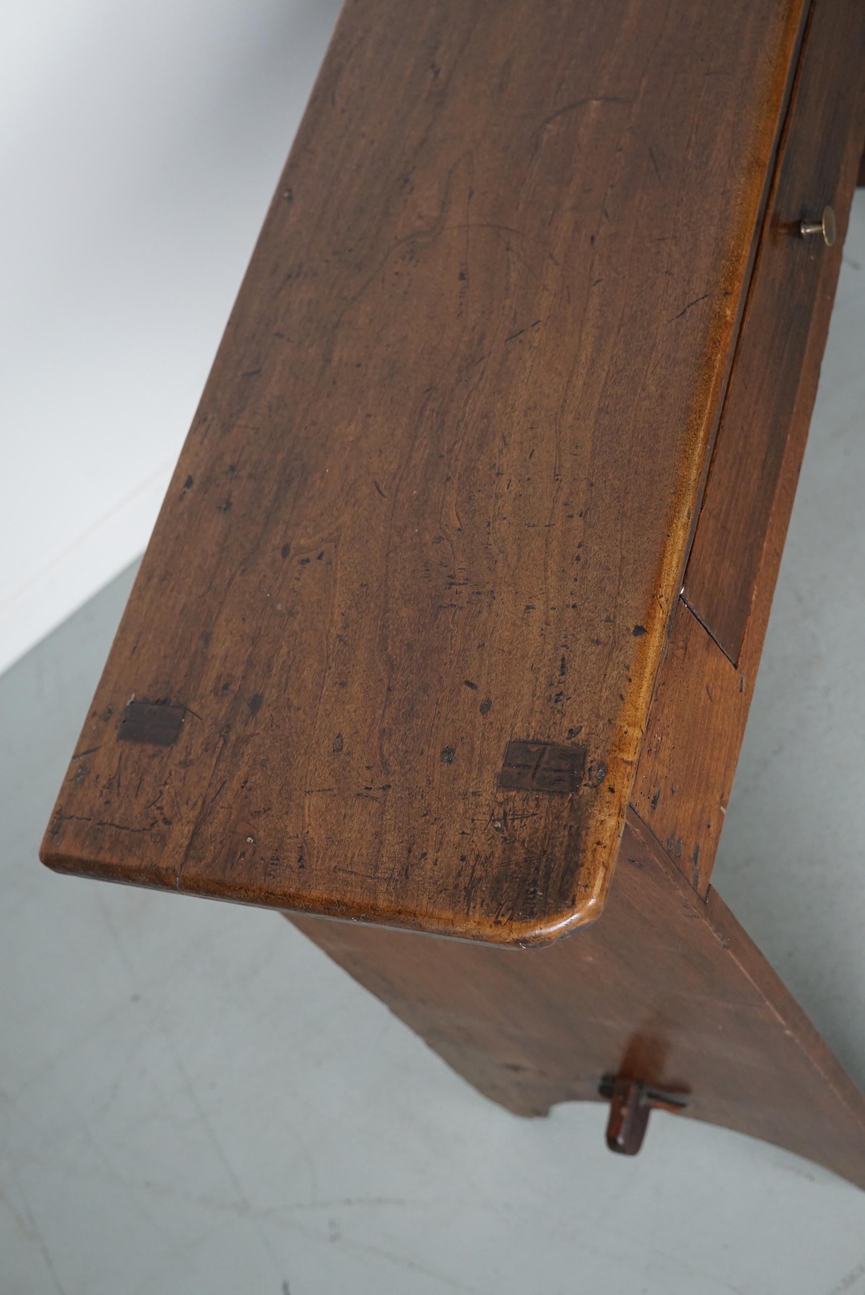 This elegant table was made in France from fruitwood with beautiful grain patterns. It has a warm color with deep gloss and the table shows many marks of use and has great patina.