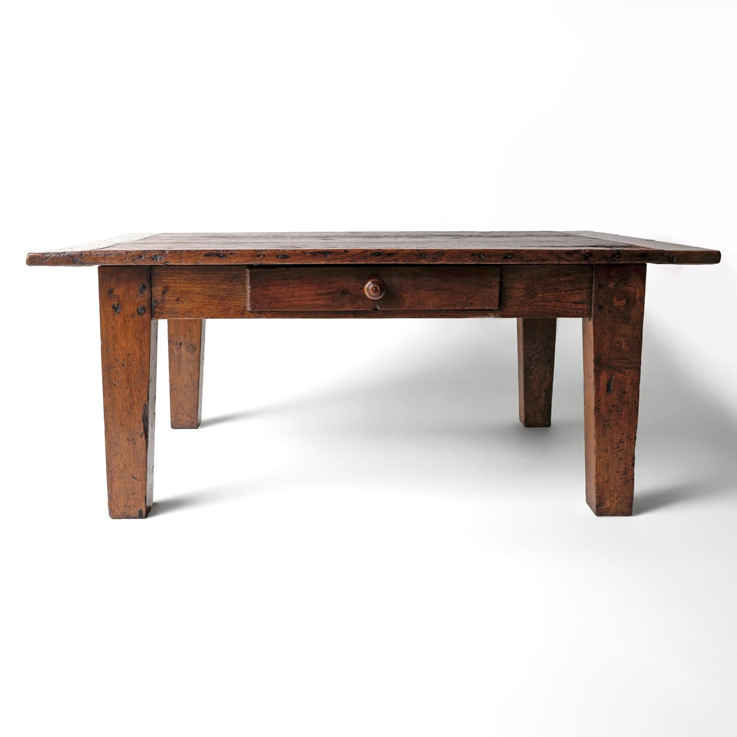 ANTIQUE COFFEE TABLE 

Provincial oak low table originating from France in the 18th century.

At some point, probably during the 20th century, it was converted from a taller table to make a low coffee table.   

Drawer to one side with original